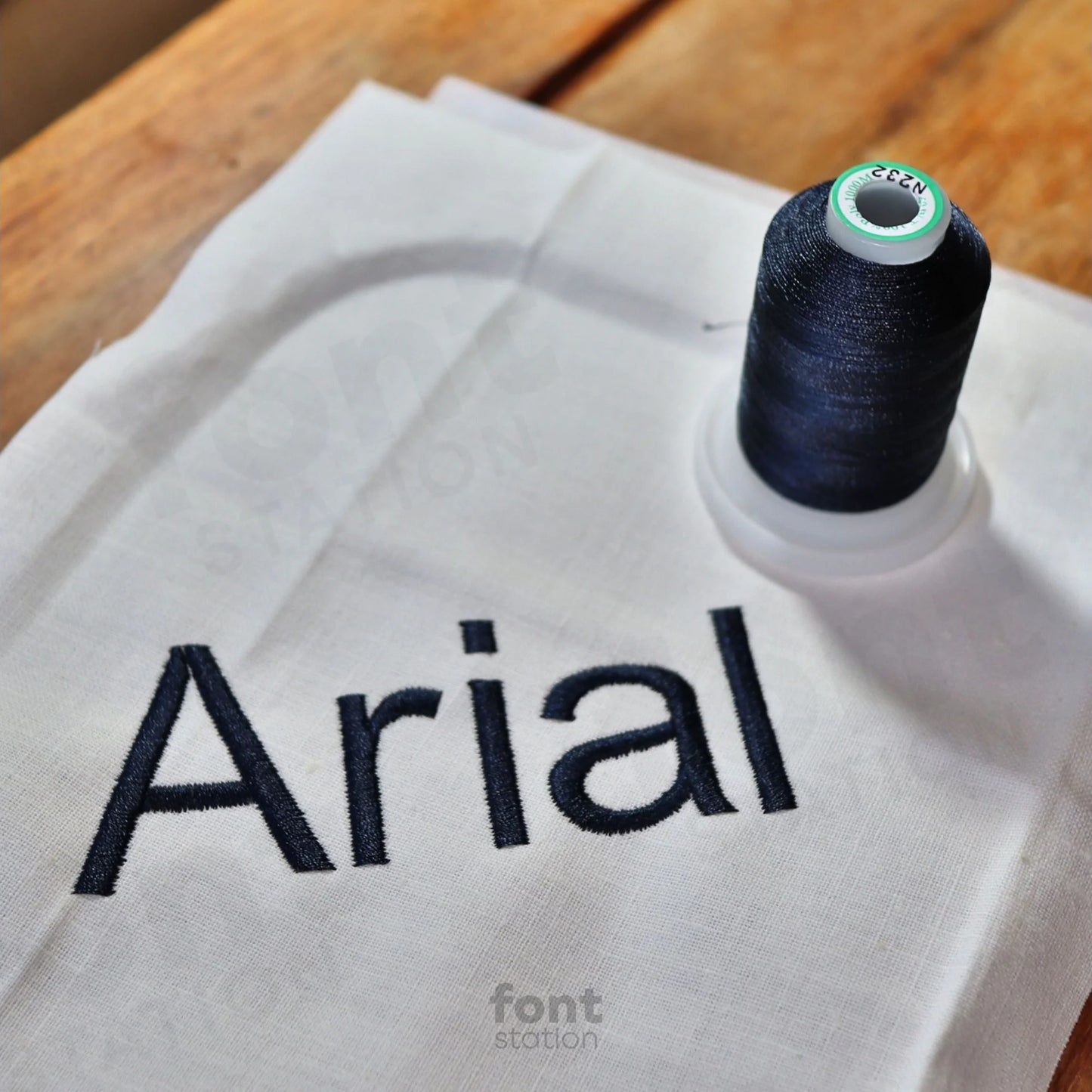 Image showing a word embroidered on textile using the Arial embroidery font created by FontStation