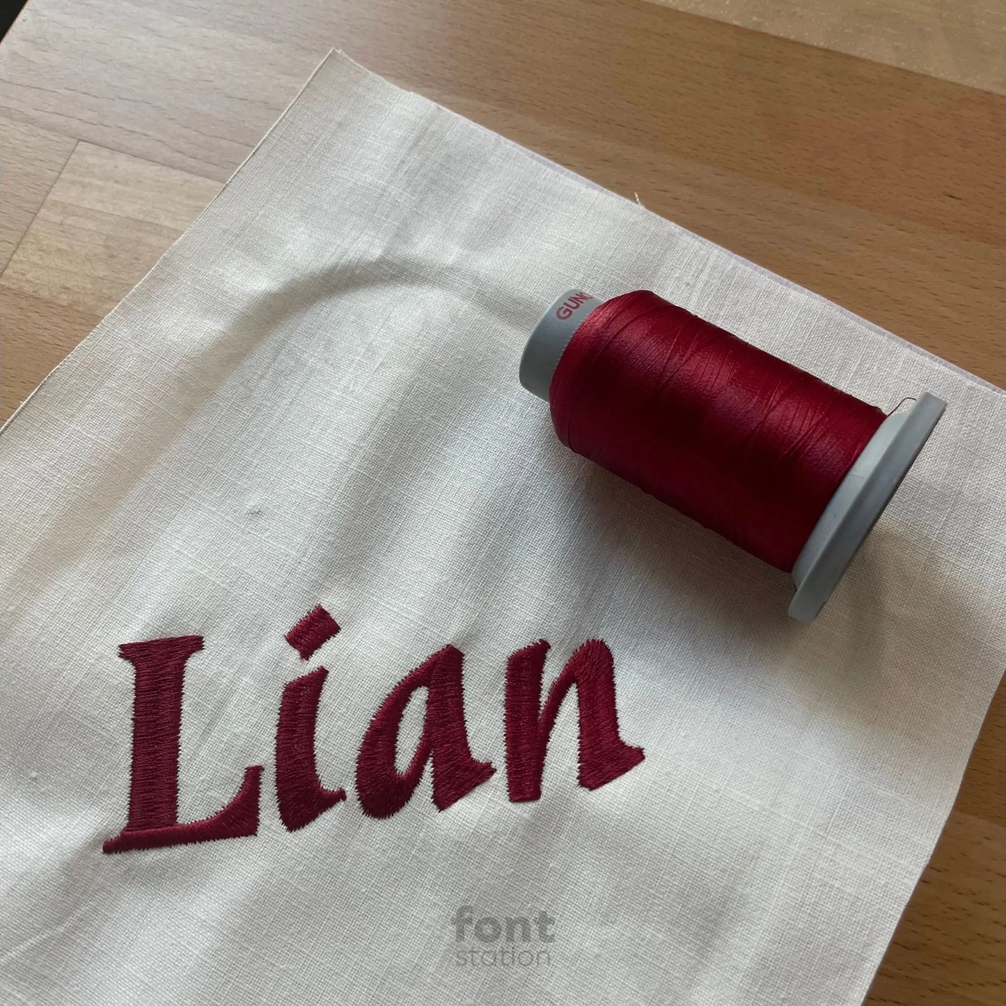 Image showing a word embroidered on textile using the Asian embroidery font created by FontStation