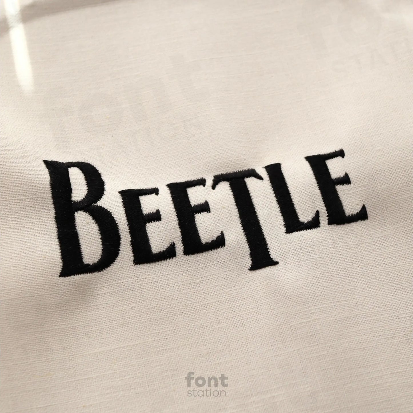 Image showing a word embroidered on textile using the Beatles embroidery font created by FontStation