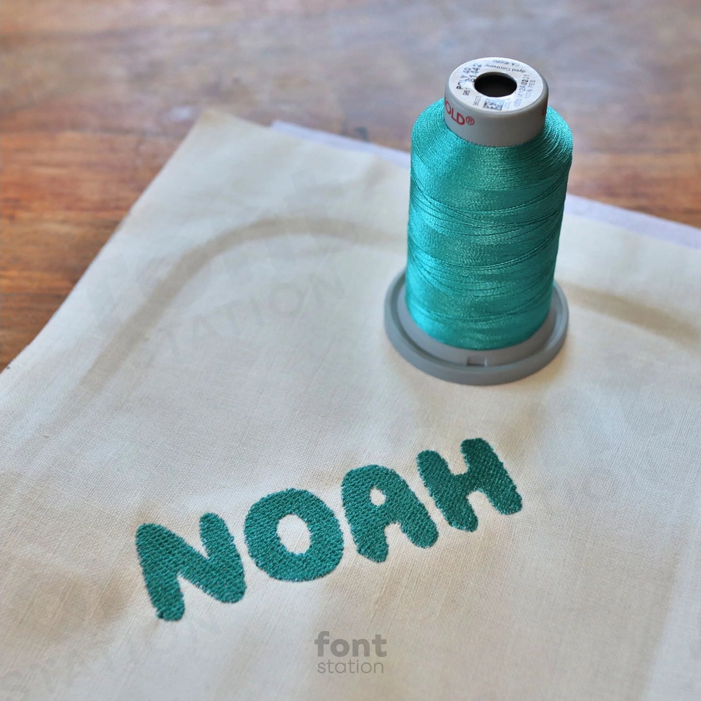 Image showing a word embroidered on textile using the Bubble embroidery font created by FontStation