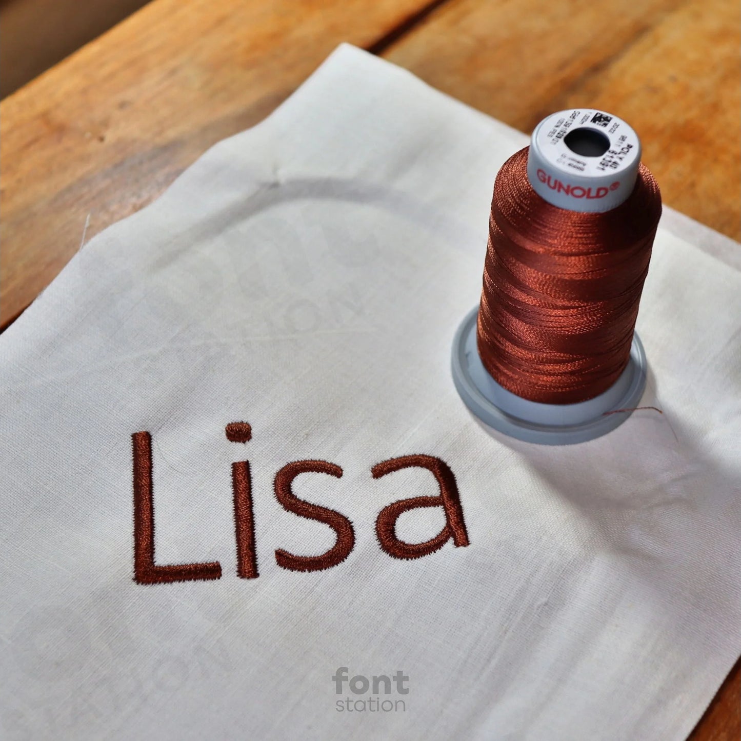 Image showing a word embroidered on textile using the Calibri embroidery font created by FontStation