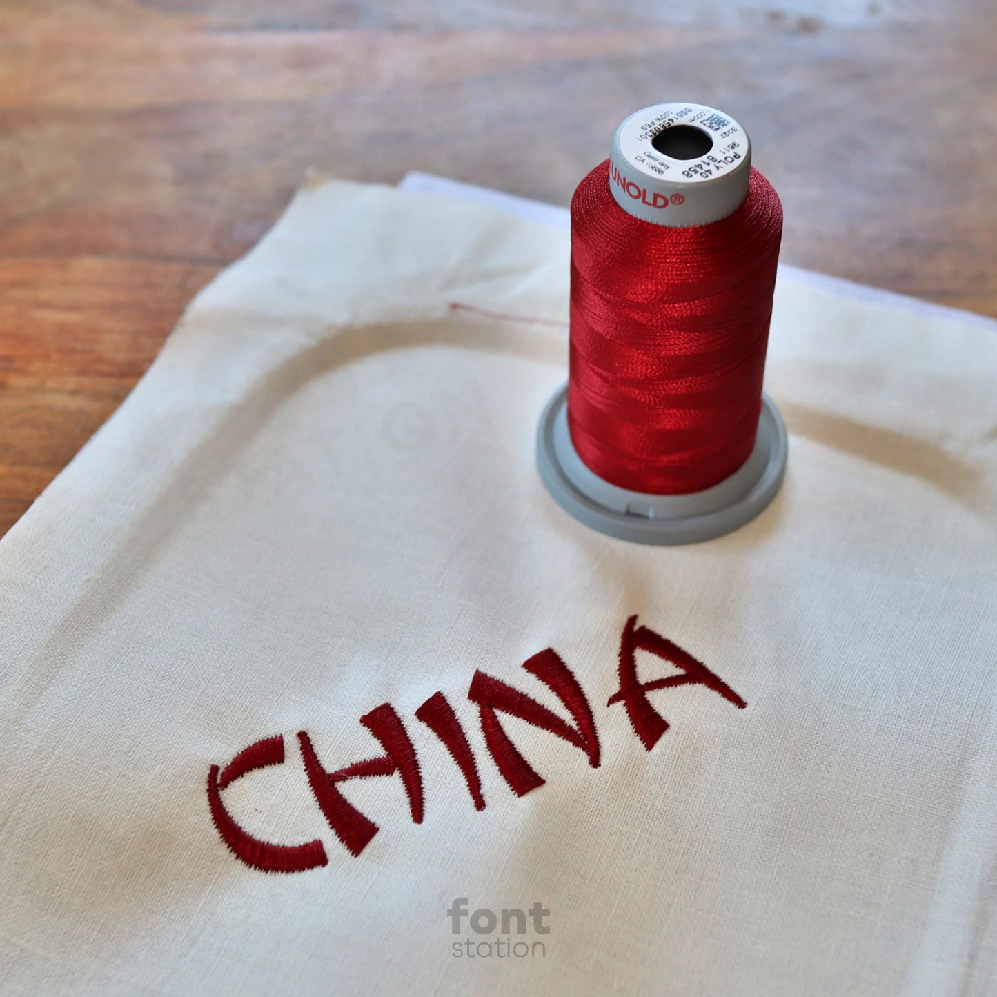 Image showing a word embroidered on textile using the Chinese embroidery font created by FontStation