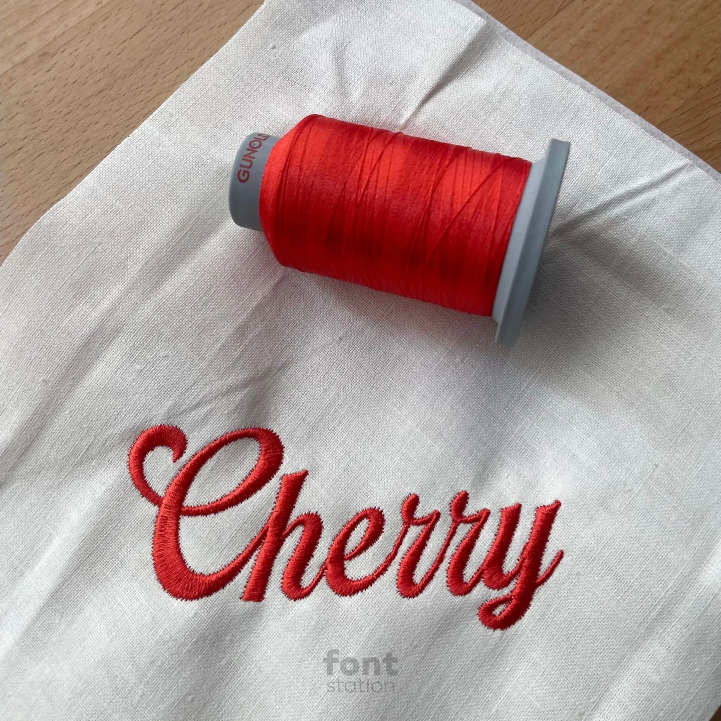 Image showing a word embroidered on textile using the Delicious embroidery font created by FontStation