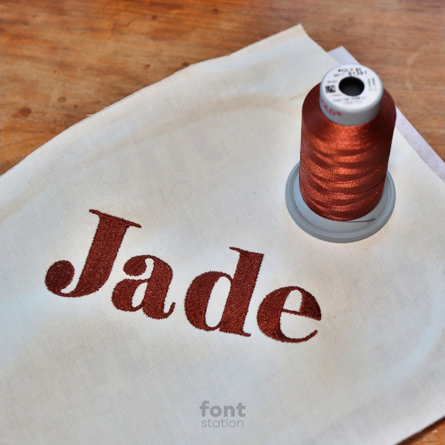Image showing a word embroidered on textile using the Elegant Bold embroidery font created by FontStation