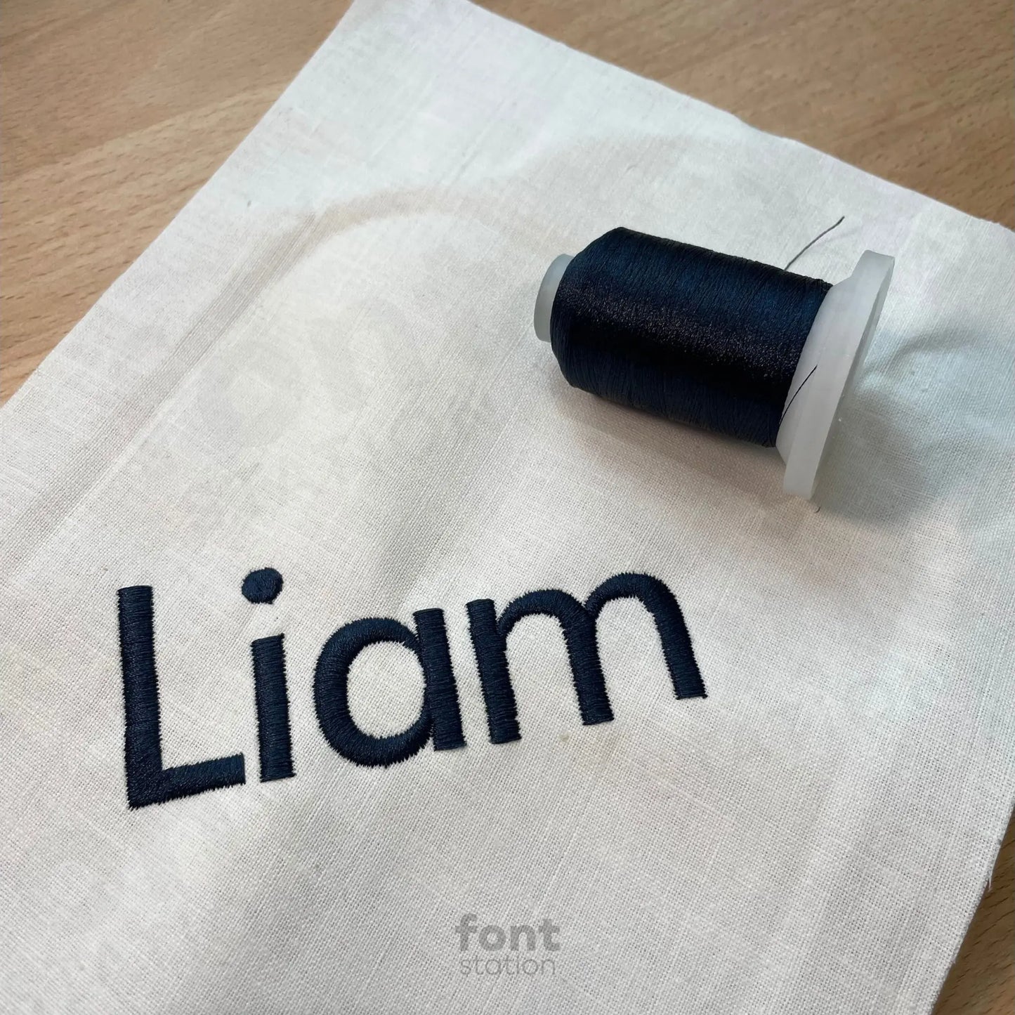 Image showing a word embroidered on textile using the Futura Bold embroidery font created by FontStation