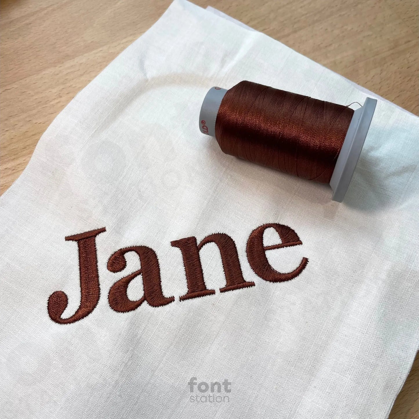 Image showing a word embroidered on textile using the Georgia Bold embroidery font created by FontStation