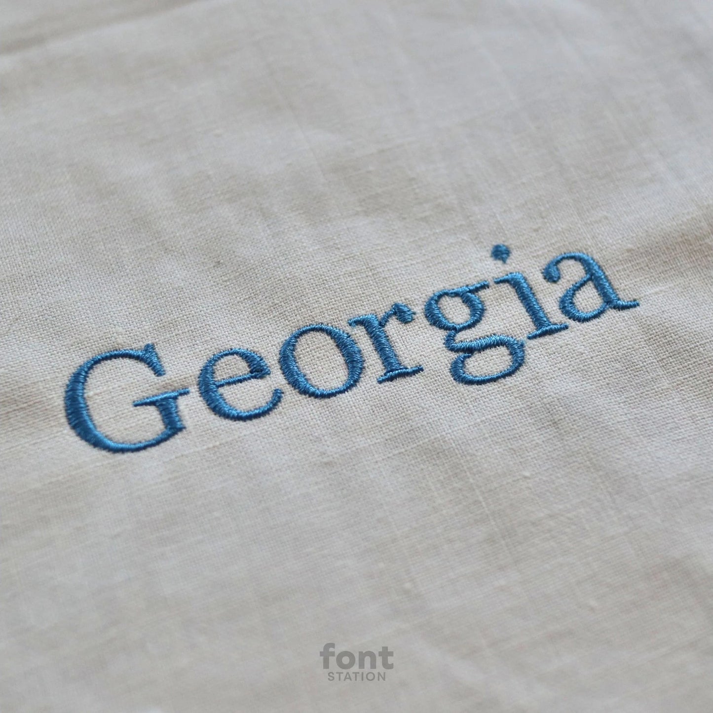 Image showing a word embroidered on textile using the Georgia embroidery font created by FontStation
