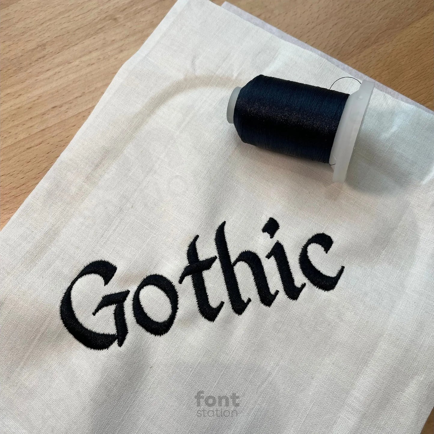 Image showing a word embroidered on textile using the Gothic embroidery font created by FontStation