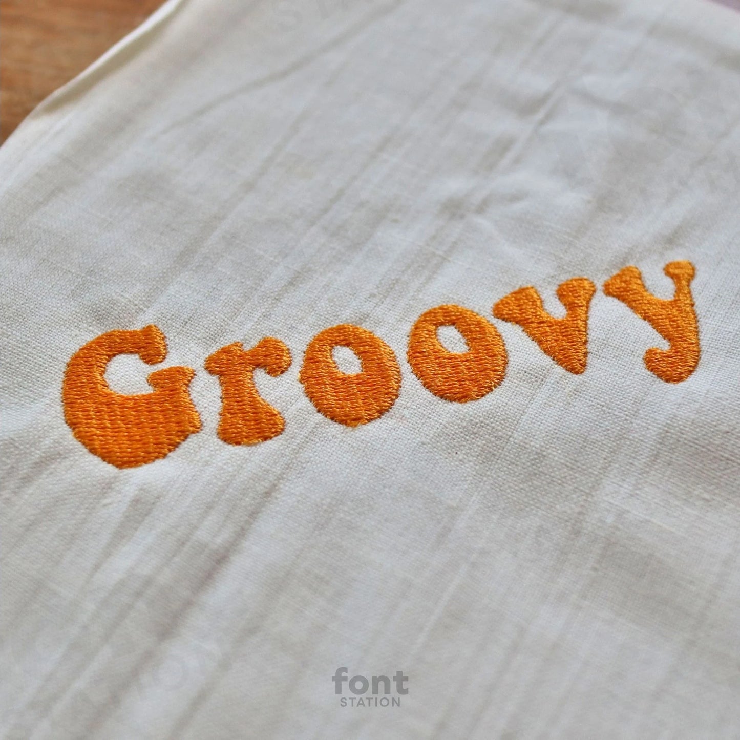 Image showing a word embroidered on textile using the Groovy embroidery font created by FontStation