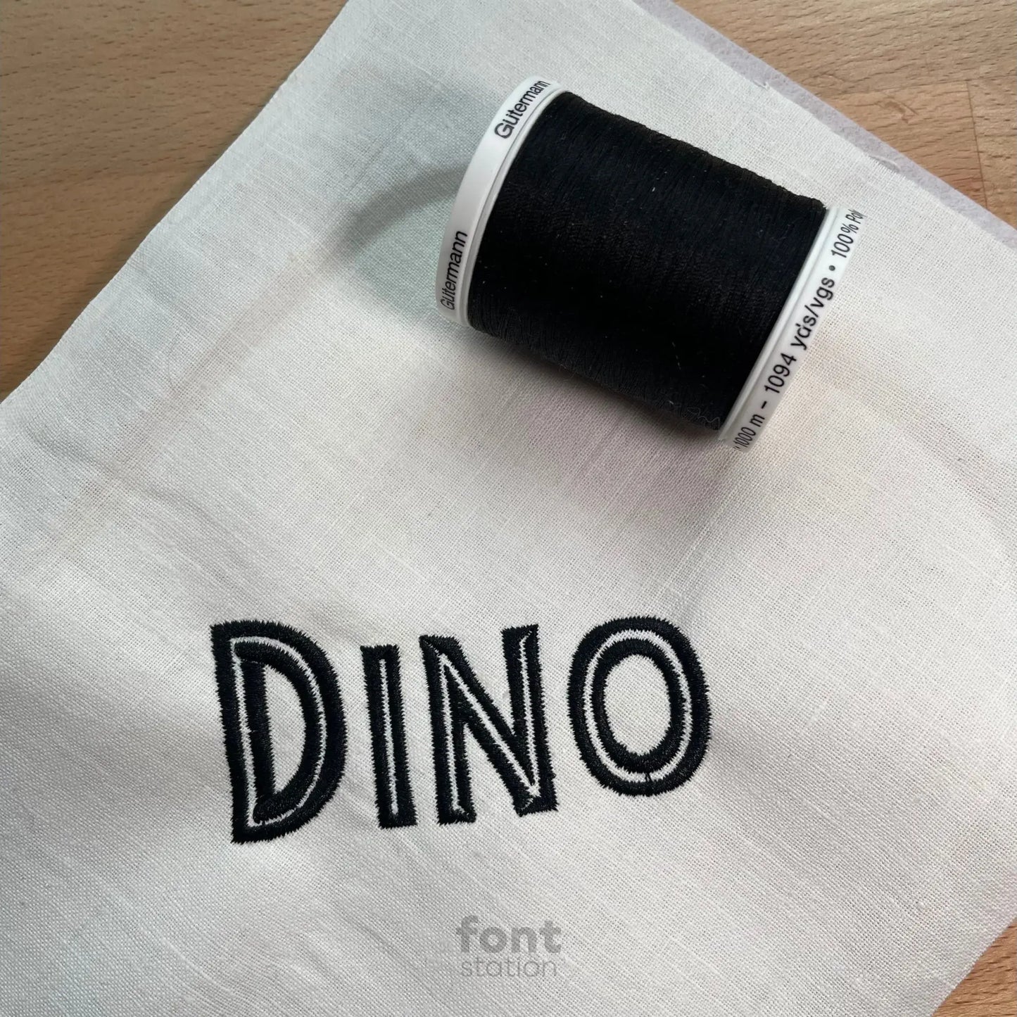 Image showing a word embroidered on textile using the Jurassic embroidery font created by FontStation