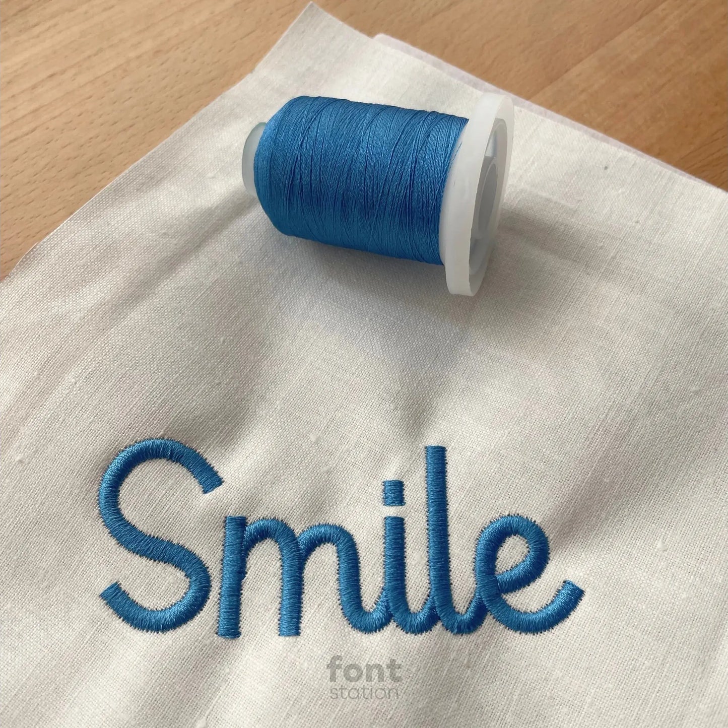 Image showing a word embroidered on textile using the Kids Cursive embroidery font created by FontStation