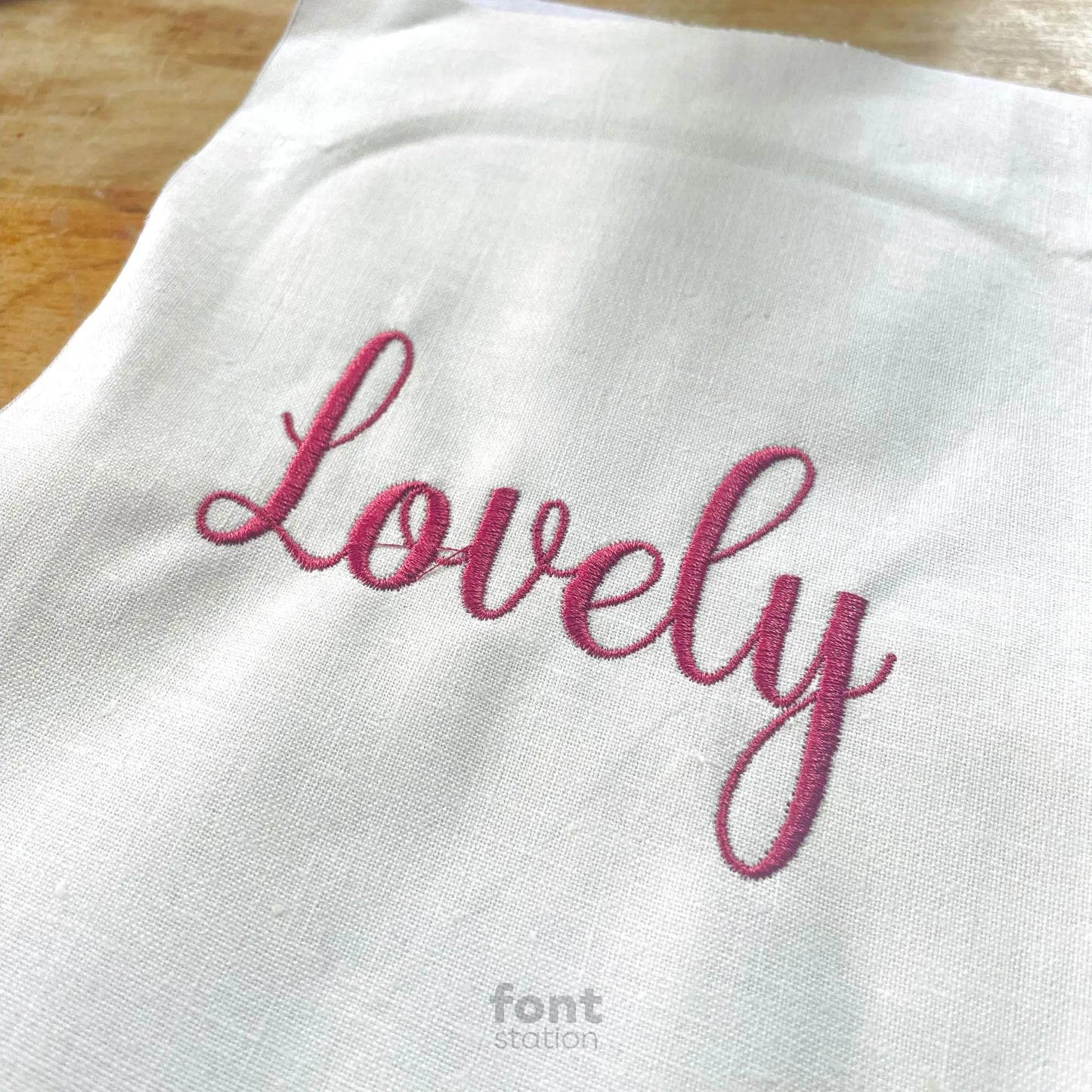 Image showing a word embroidered on textile using the Lovely embroidery font created by FontStation