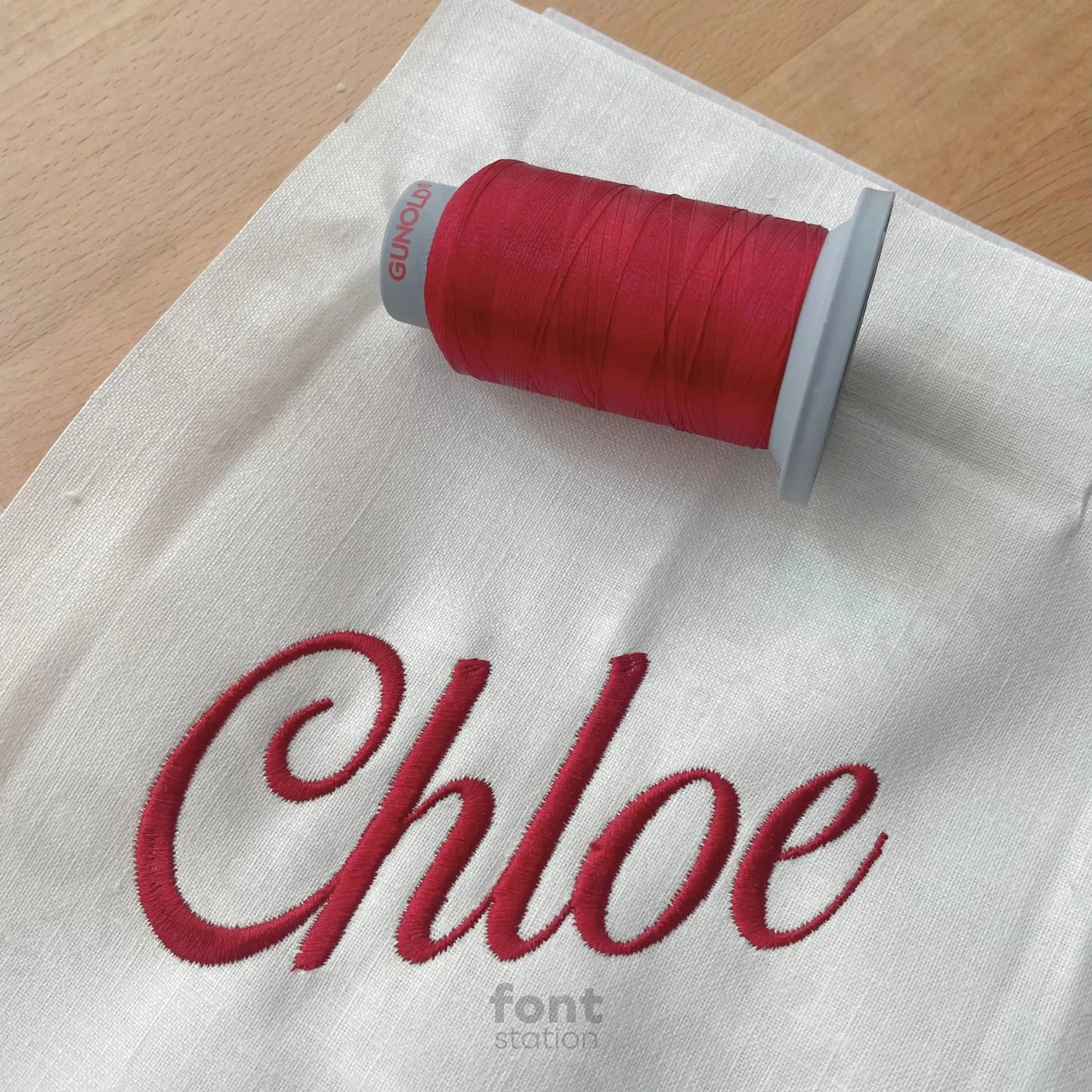 Image showing a word embroidered on textile using the Madame embroidery font created by FontStation