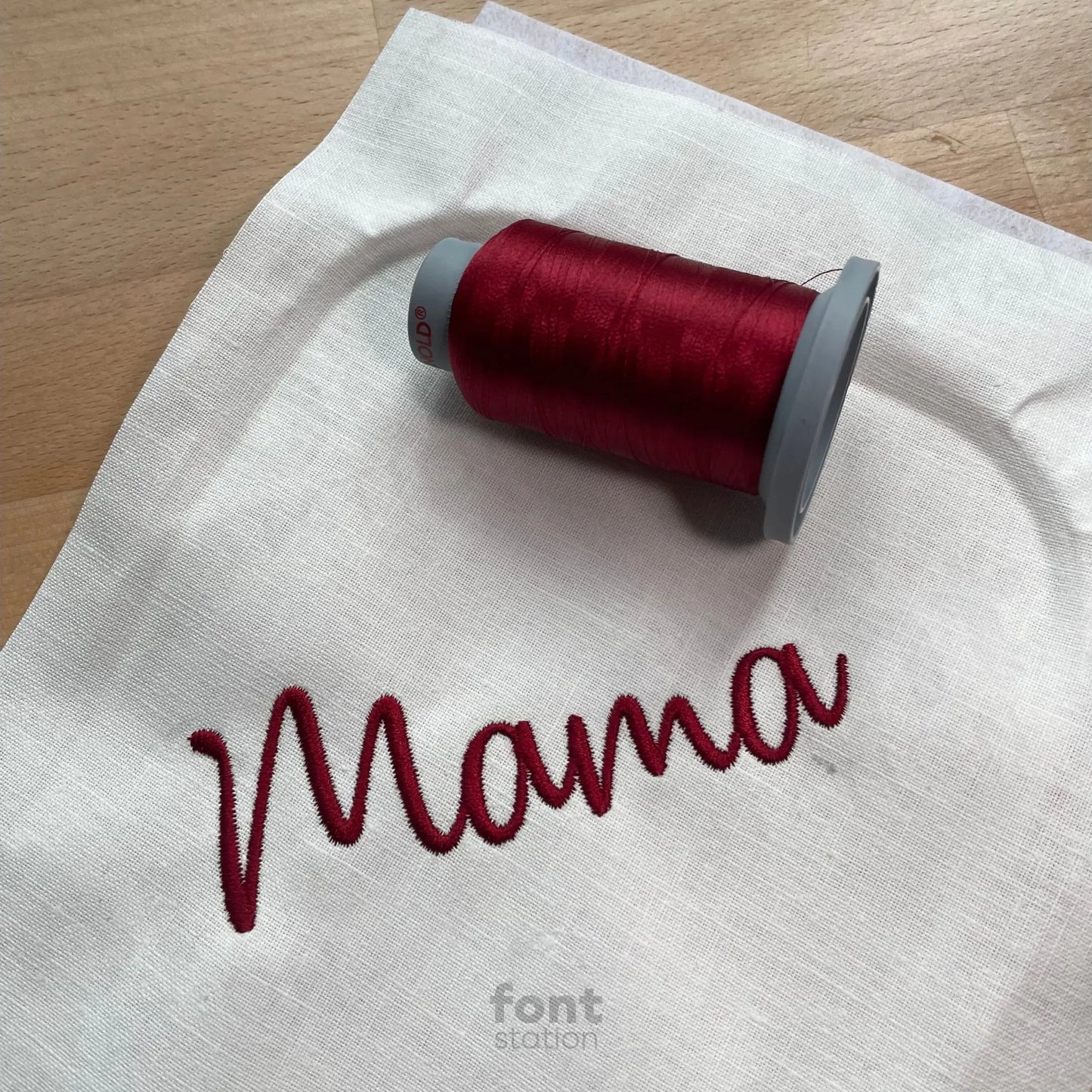 Image showing a word embroidered on textile using the Mama embroidery font created by FontStation