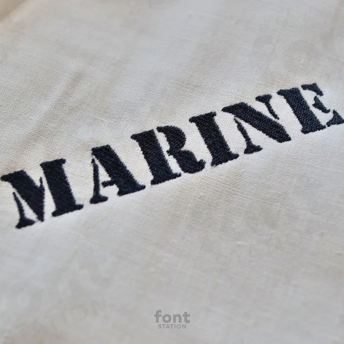 Image showing a word embroidered on textile using the Marine embroidery font created by FontStation
