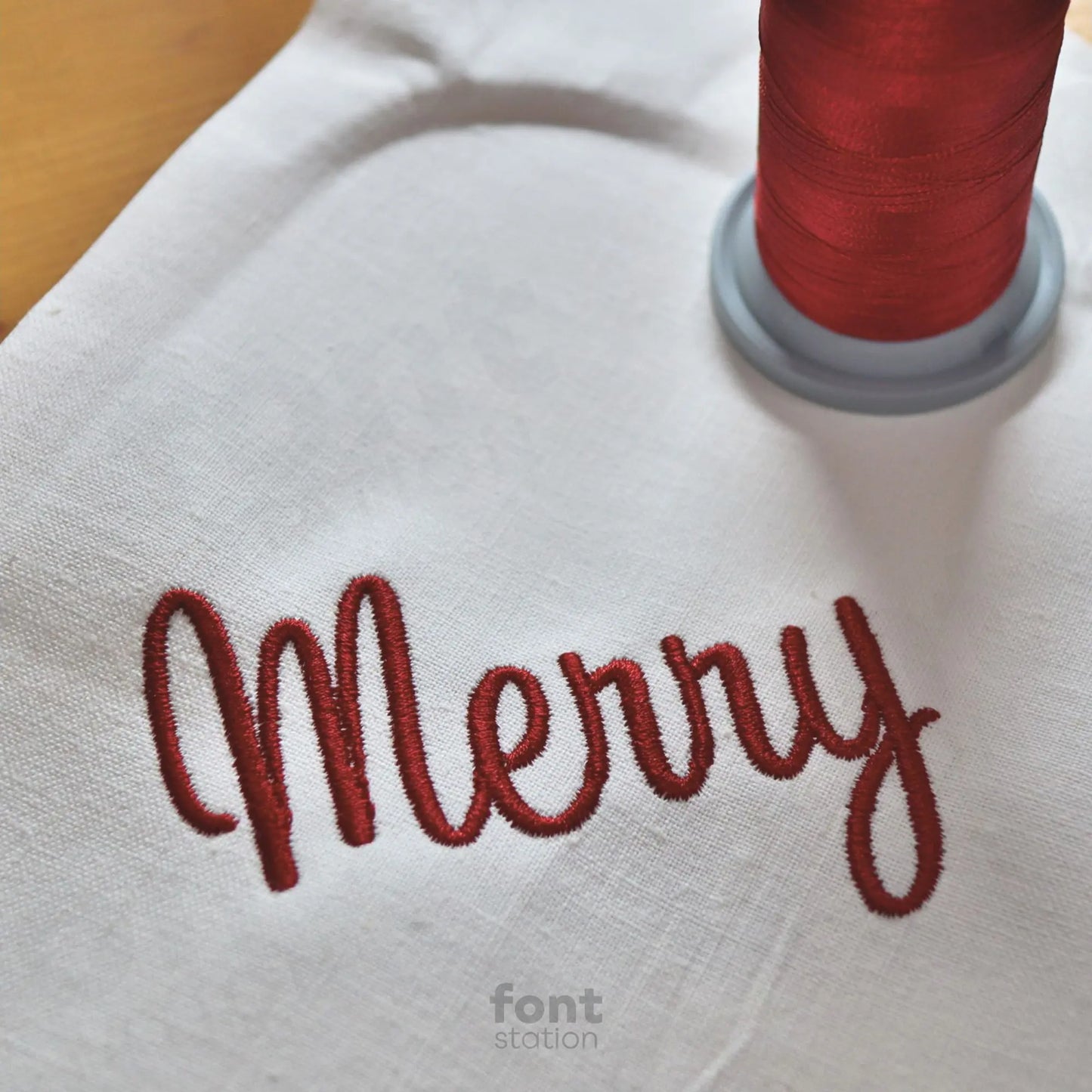 Image showing a word embroidered on textile using the Merry Christmas embroidery font created by FontStation