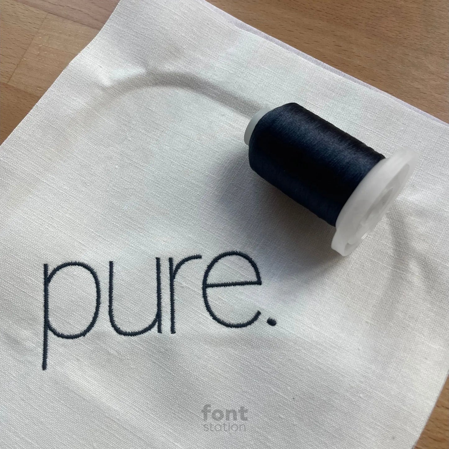 Image showing a word embroidered on textile using the Minimalist embroidery font created by FontStation