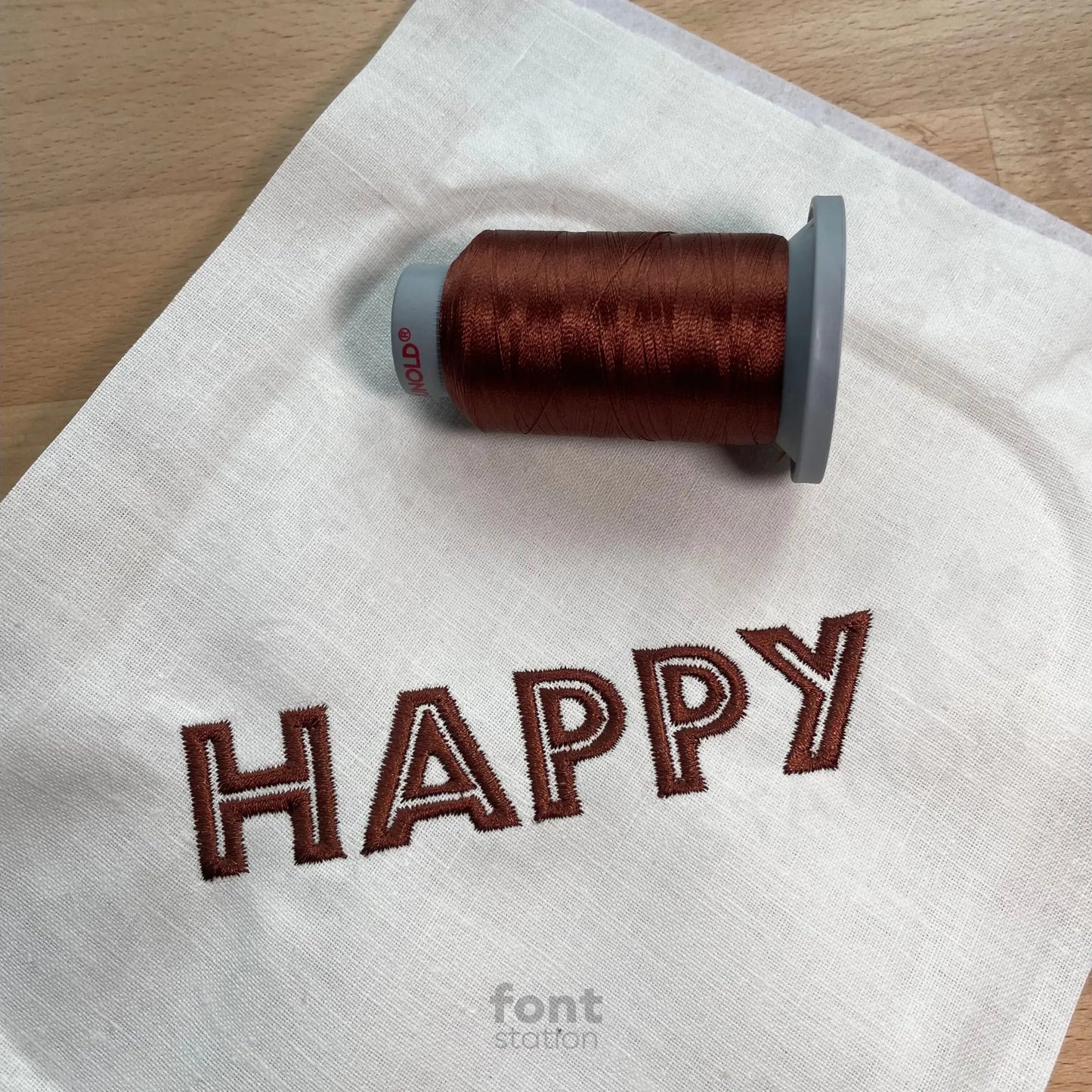 Image showing a word embroidered on textile using the Safari embroidery font created by FontStation