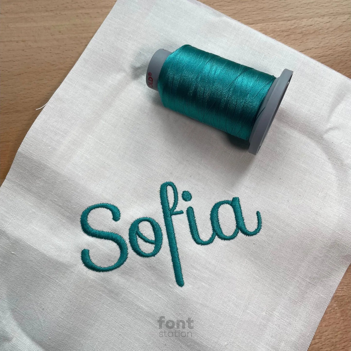 Image showing a word embroidered on textile using the Sofia embroidery font created by FontStation