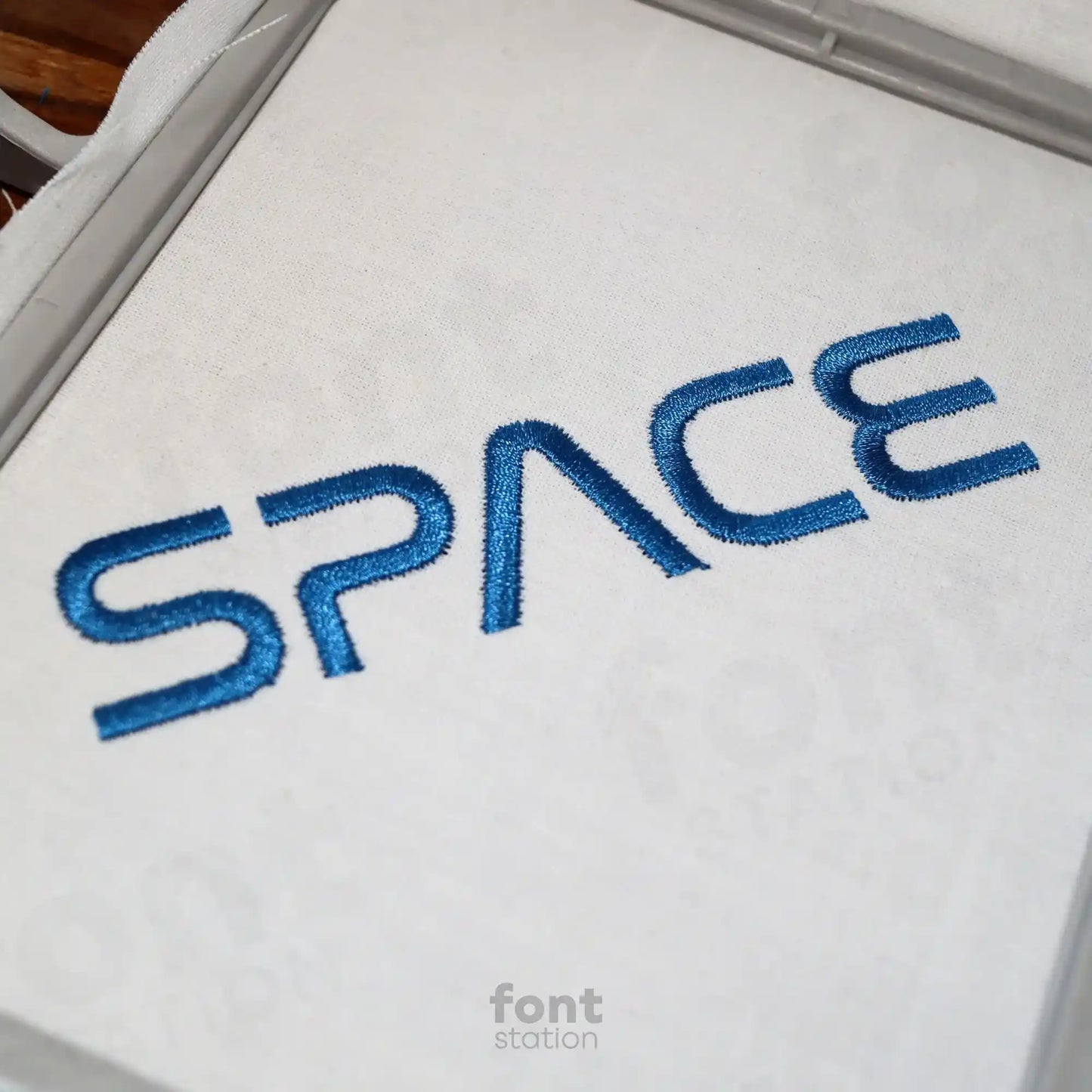 Embroidered letters using the Space embroidery font created by FontStation