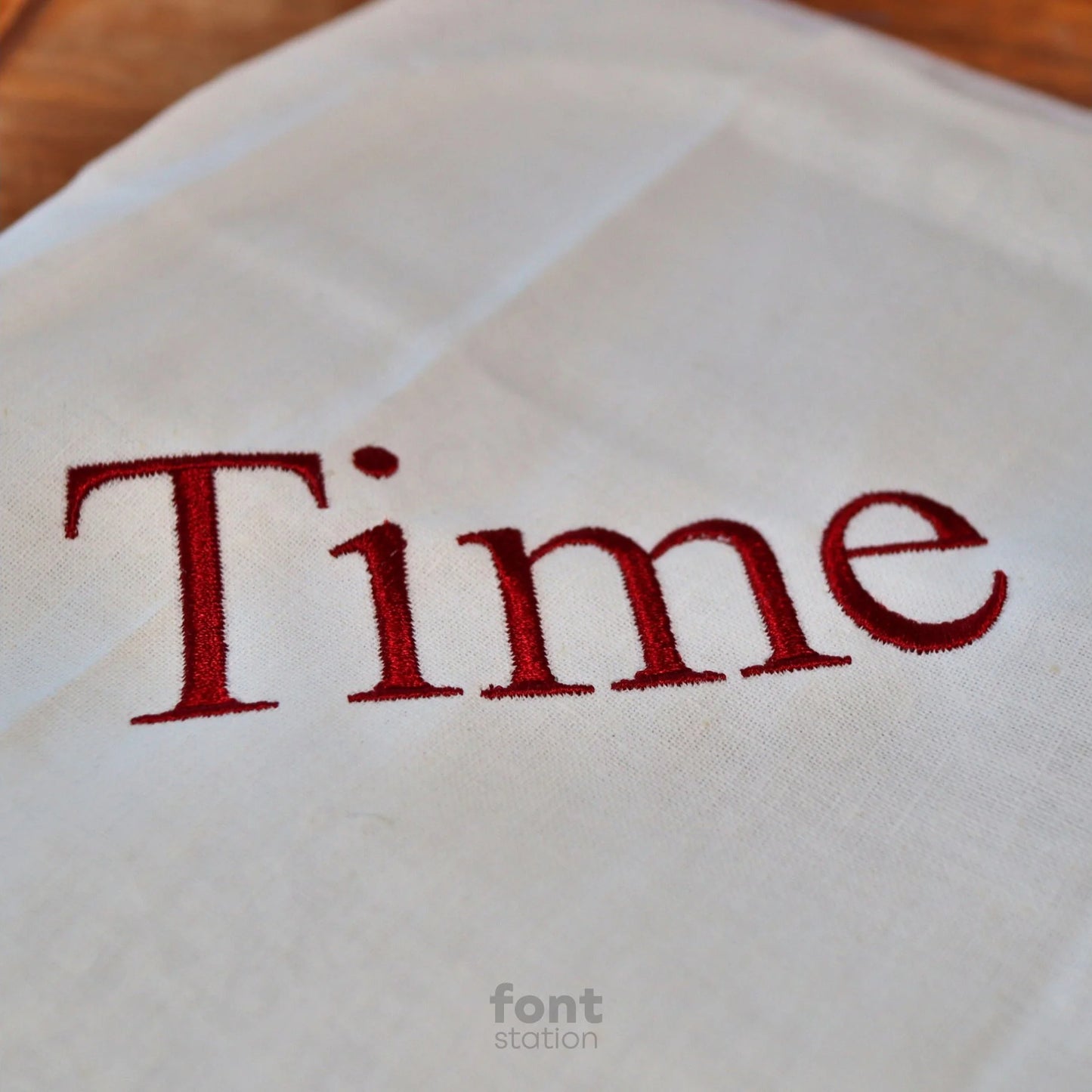 Image showing a word embroidered on textile using the Times Roman embroidery font created by FontStation