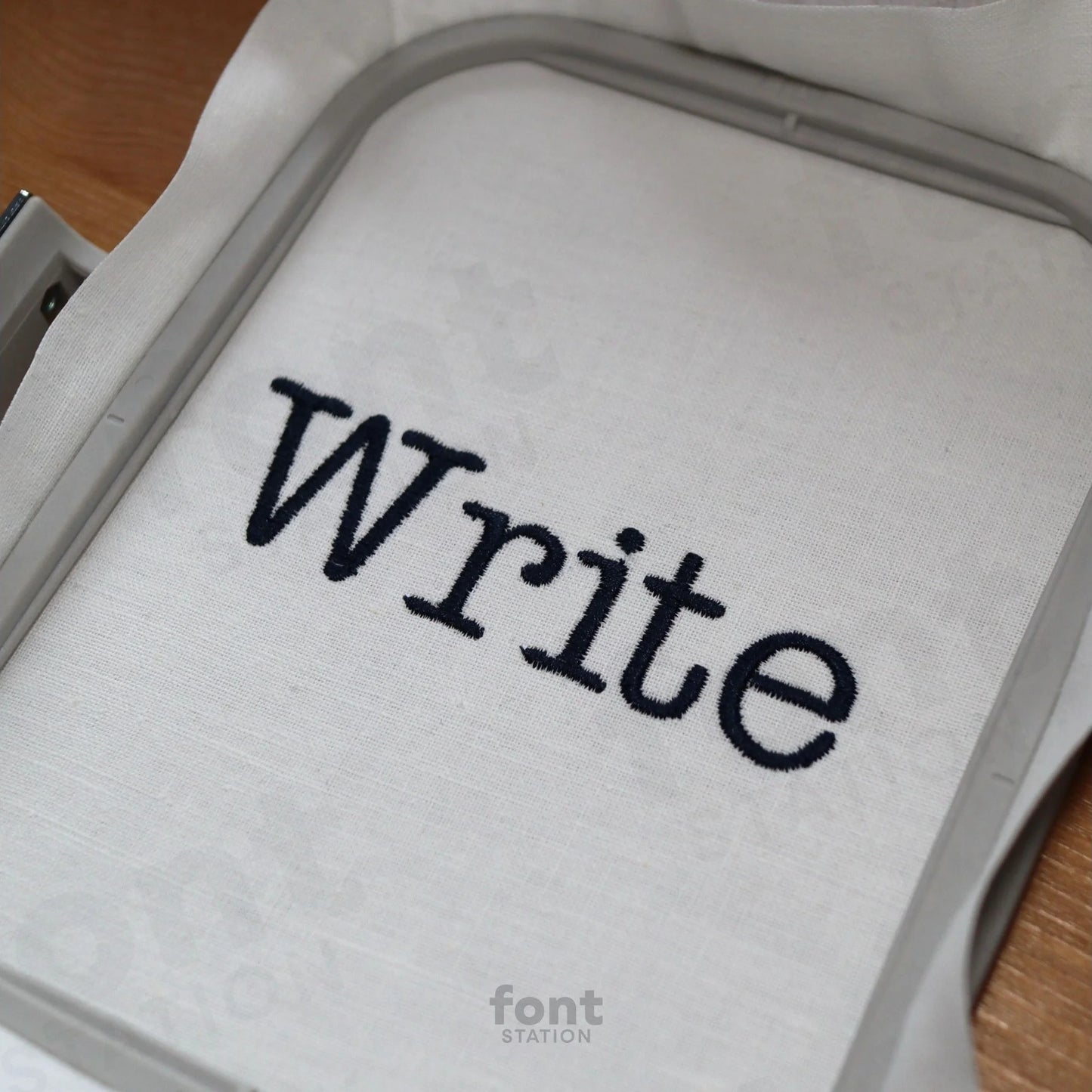 Image showing a word embroidered on textile using the Typewriter embroidery font created by FontStation