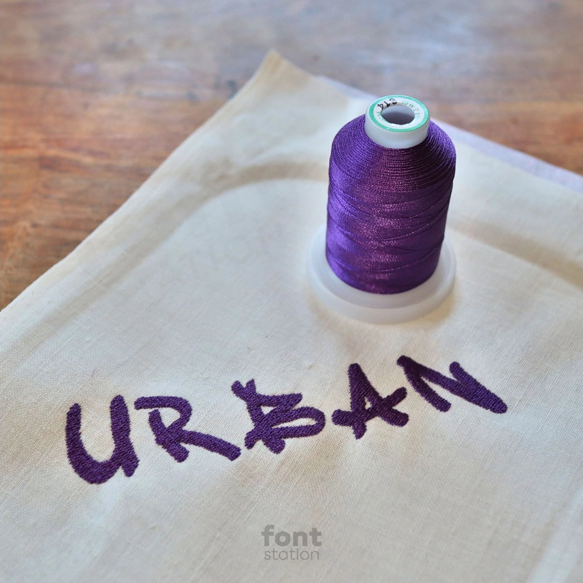 Image showing a word embroidered on textile using the Urban embroidery font created by FontStation