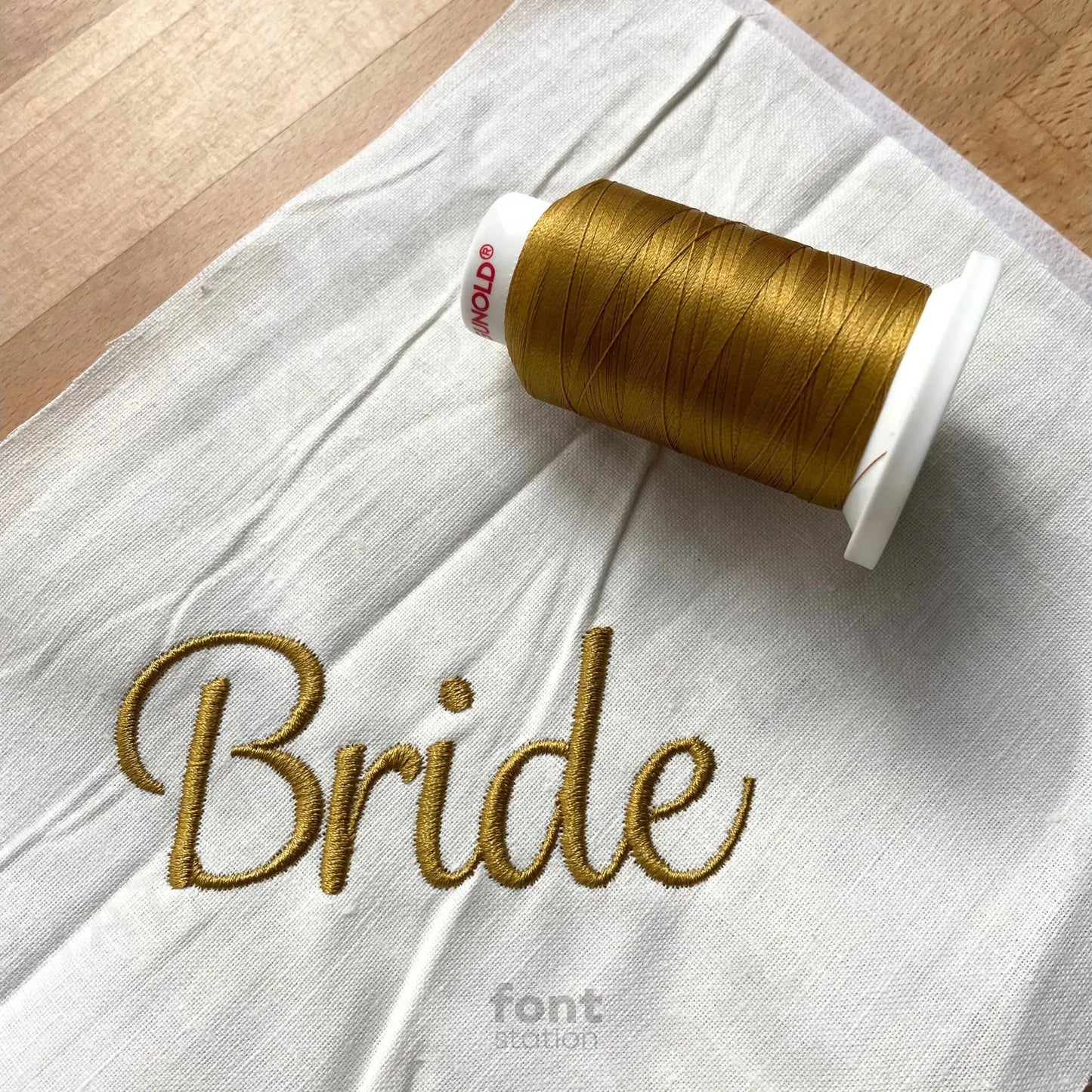 Image showing a word embroidered on textile using the Wedding embroidery font created by FontStation