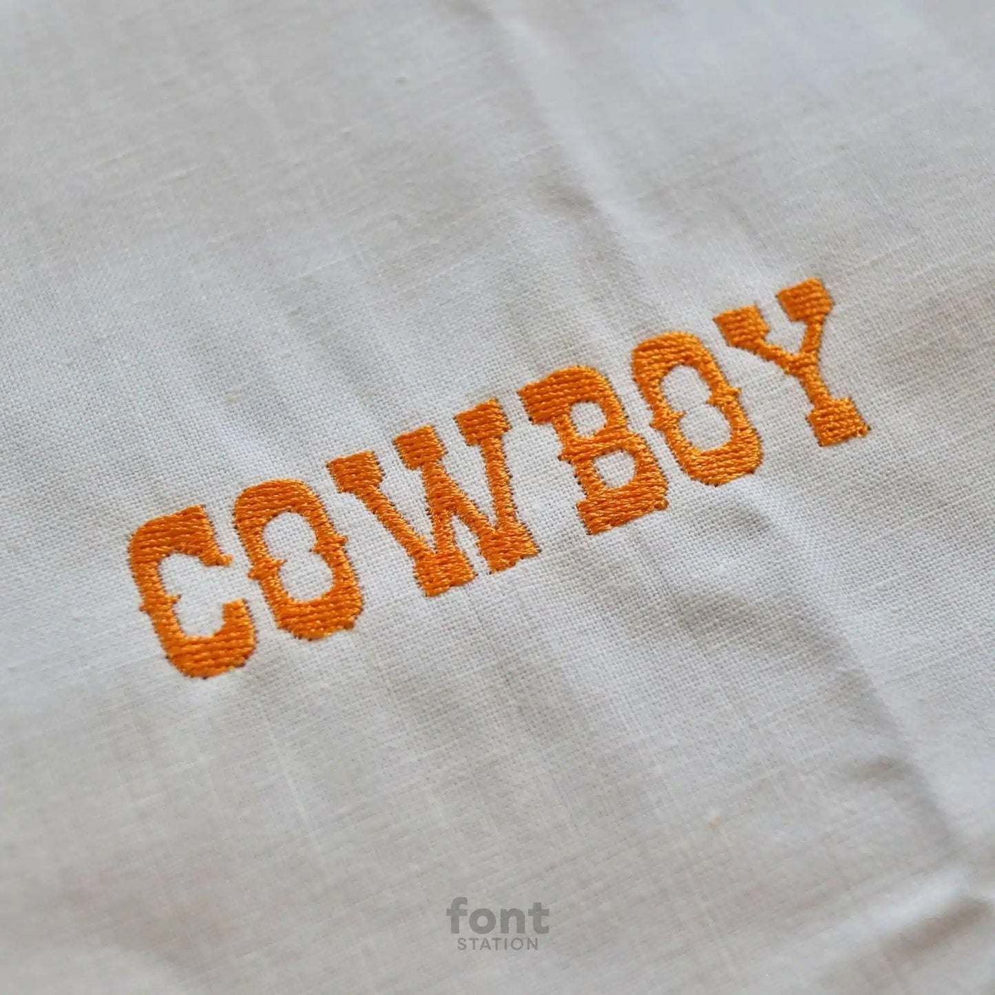 Image showing a word embroidered on textile using the Western embroidery font created by FontStation