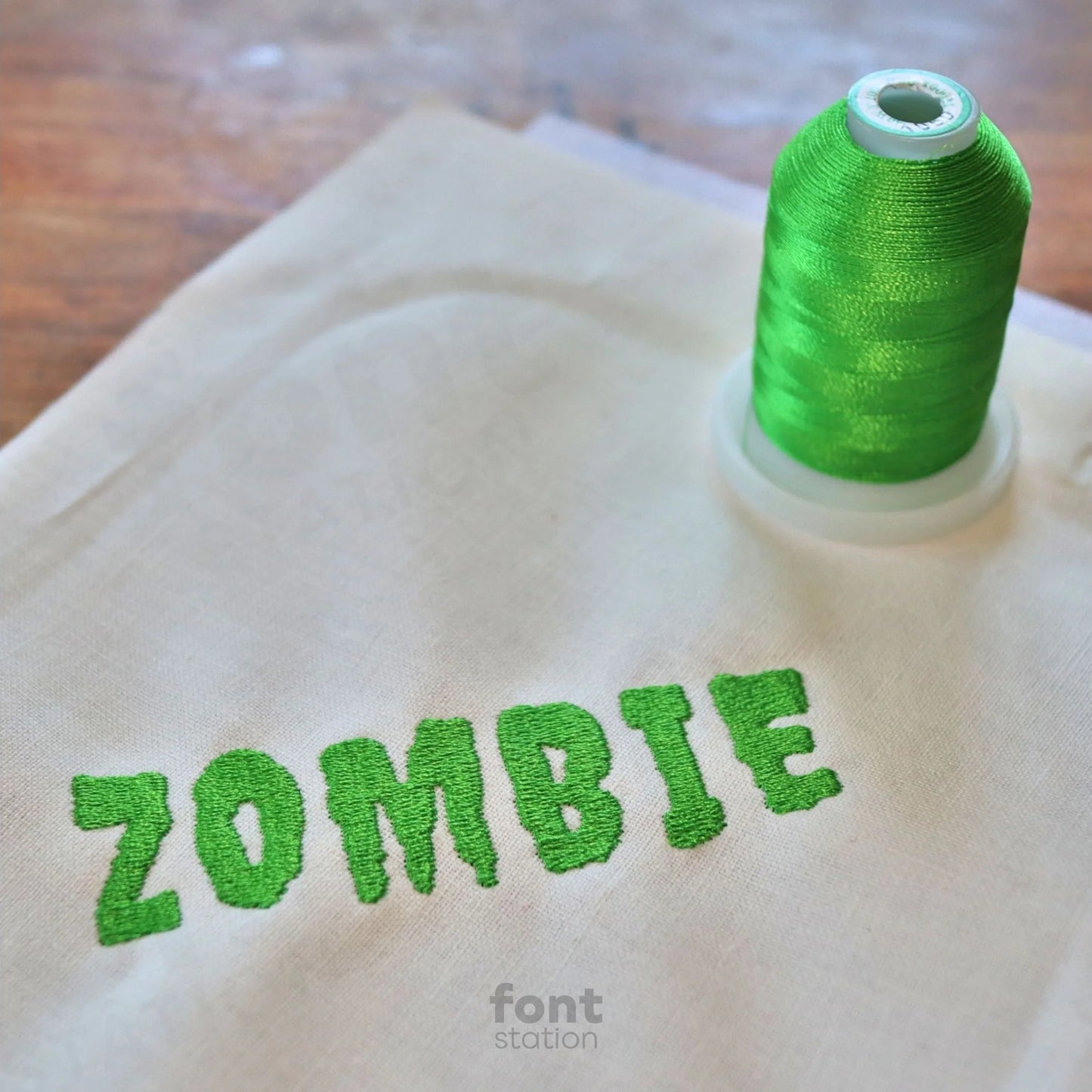 Image showing a word embroidered on textile using the Zombie embroidery font created by FontStation