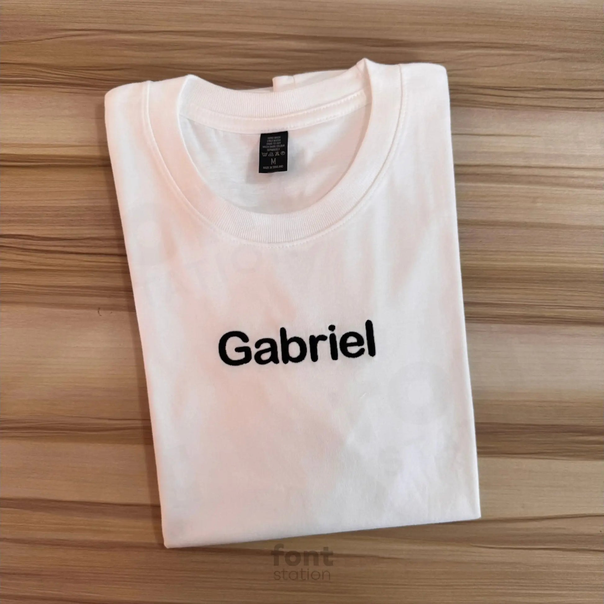 Image showing a word embroidered on textile using the Arial Rounded embroidery font created by FontStation