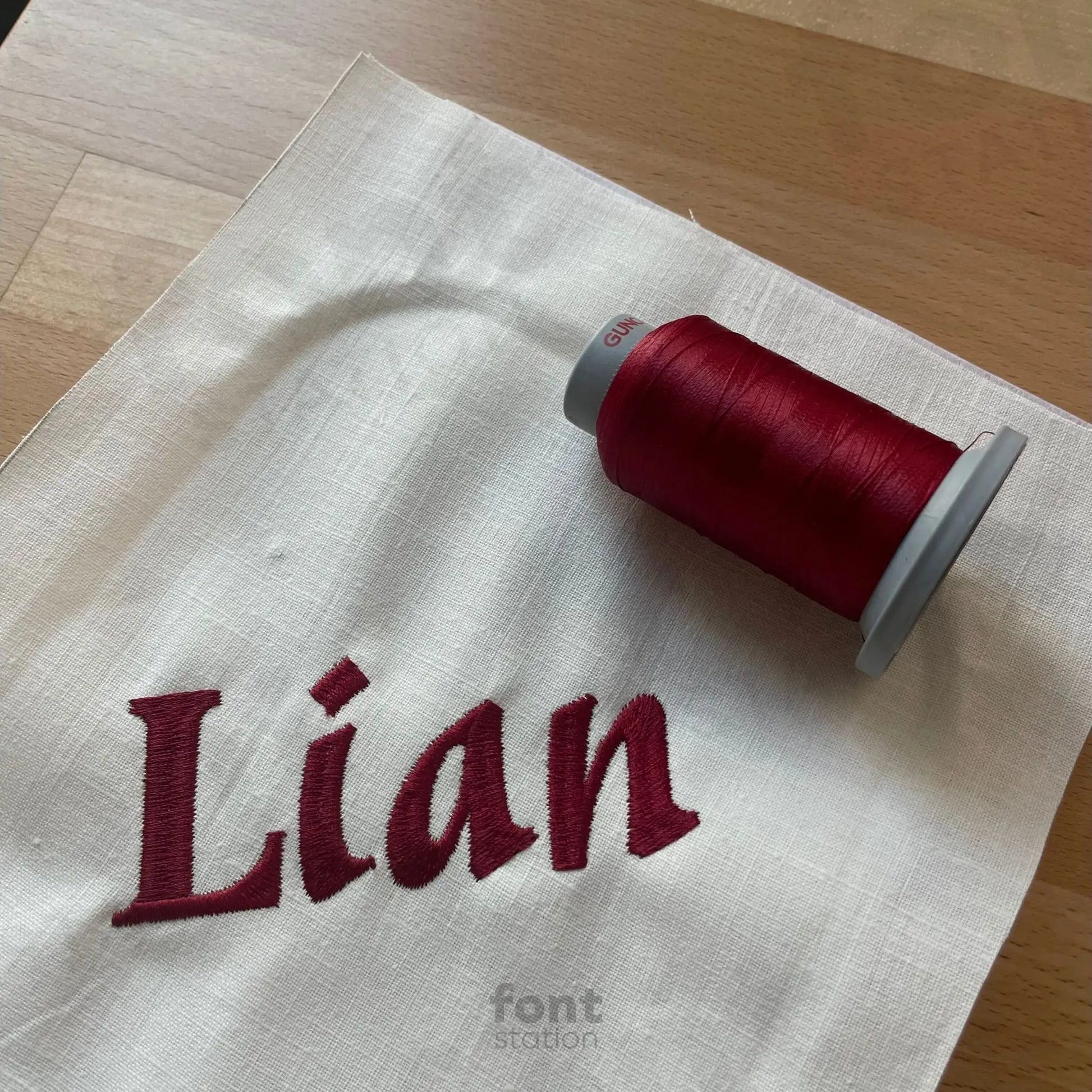 Image showing a word embroidered on textile using the Asian embroidery font created by FontStation