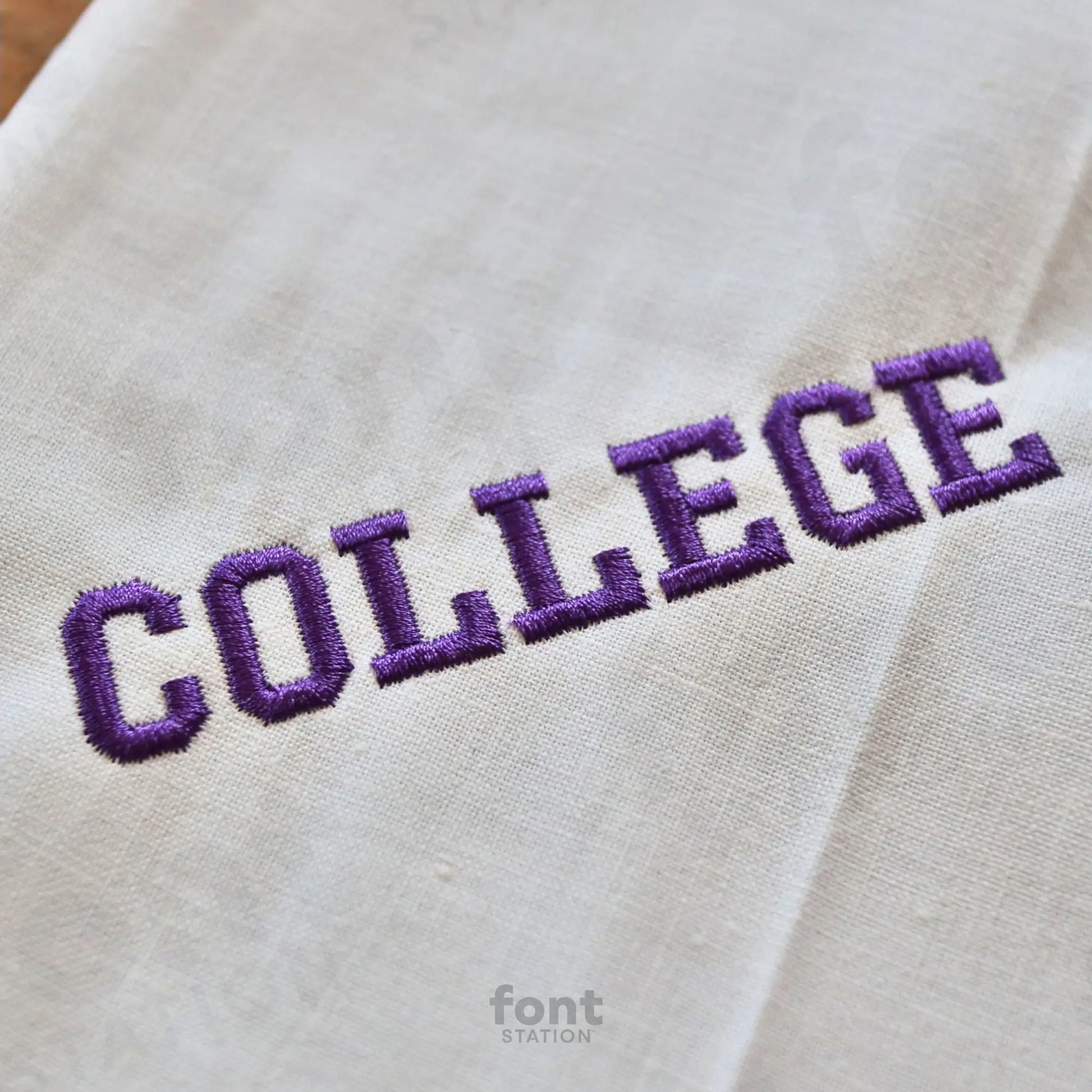 Image showing a word embroidered on textile using the College embroidery font created by FontStation