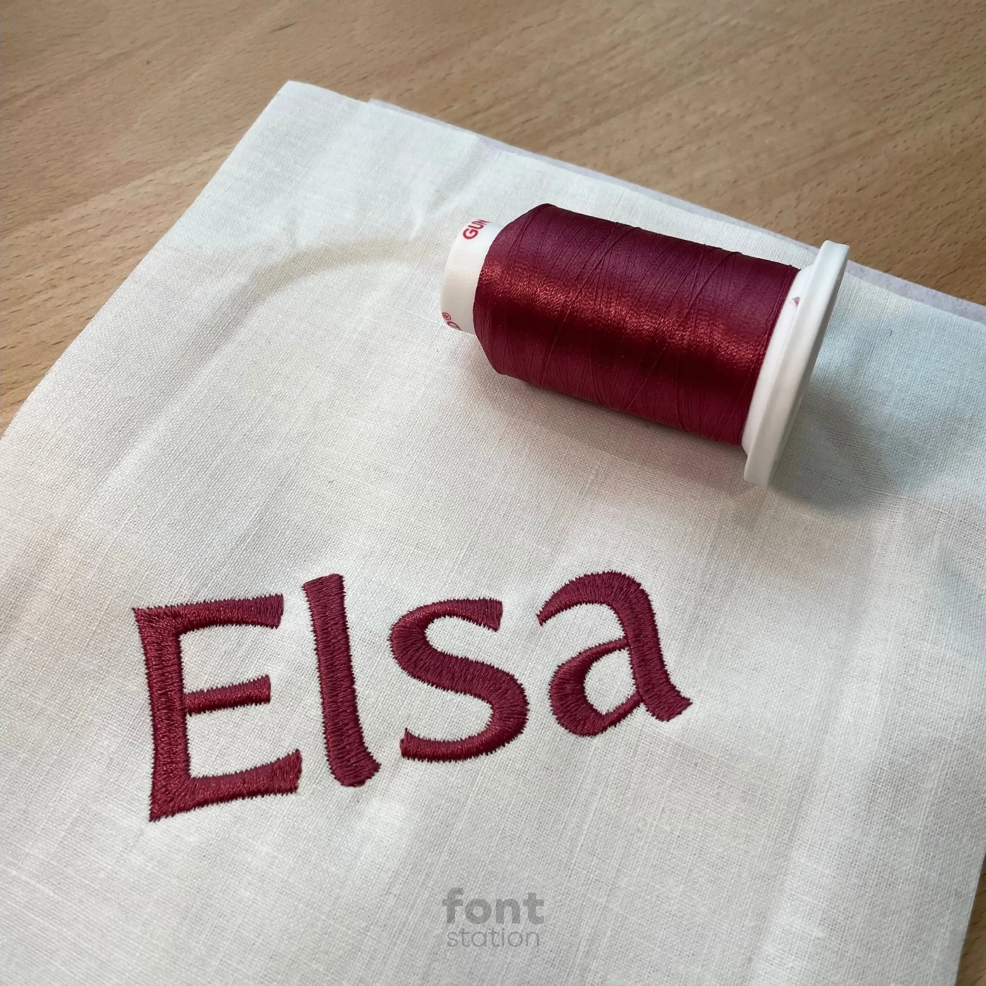 Image showing a word embroidered on textile using the Fairytale embroidery font created by FontStation