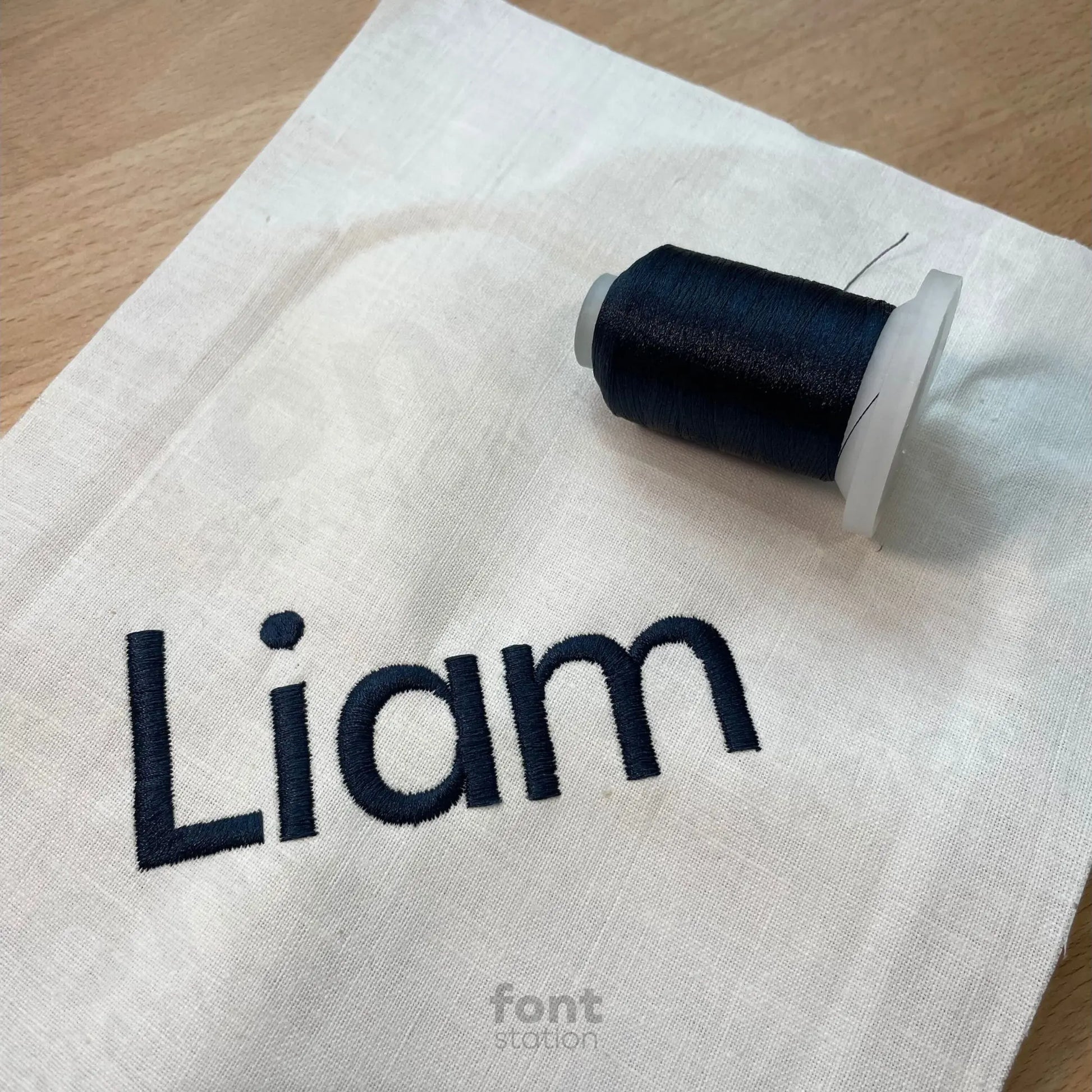 Image showing a word embroidered on textile using the Futura Bold embroidery font created by FontStation
