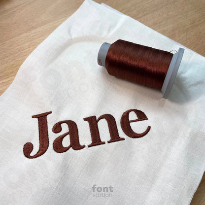 Image showing a word embroidered on textile using the Georgia Bold embroidery font created by FontStation
