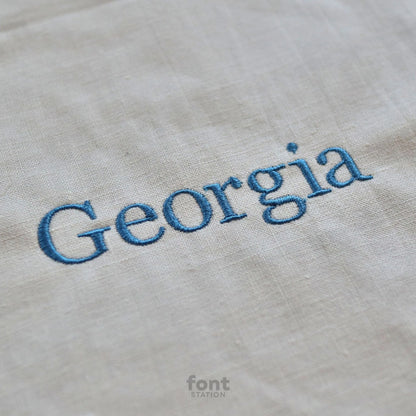 Image showing a word embroidered on textile using the Georgia embroidery font created by FontStation