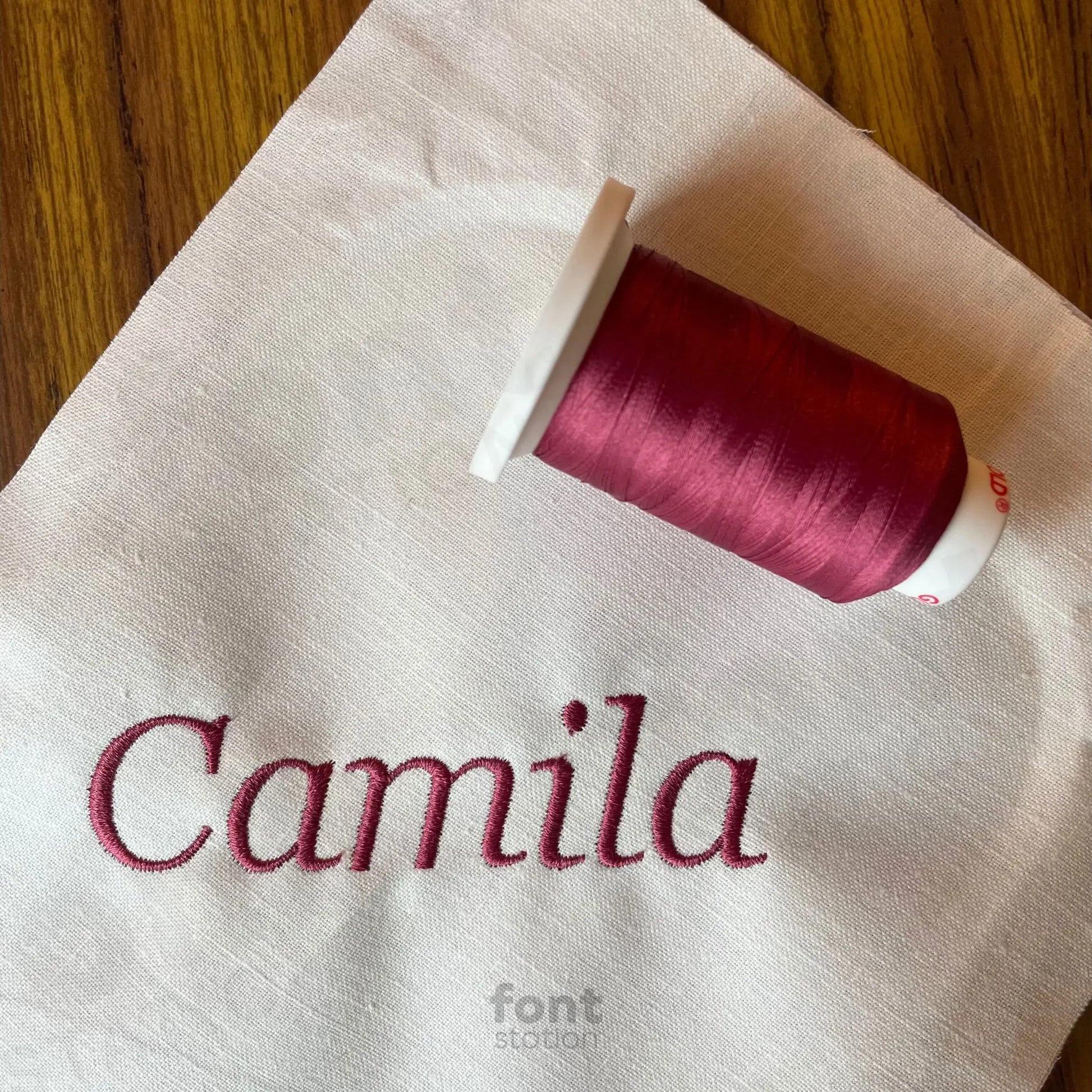 Image showing a word embroidered on textile using the Georgia Italic embroidery font created by FontStation