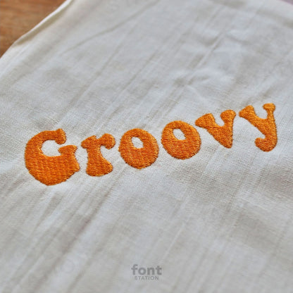 Image showing a word embroidered on textile using the Groovy embroidery font created by FontStation