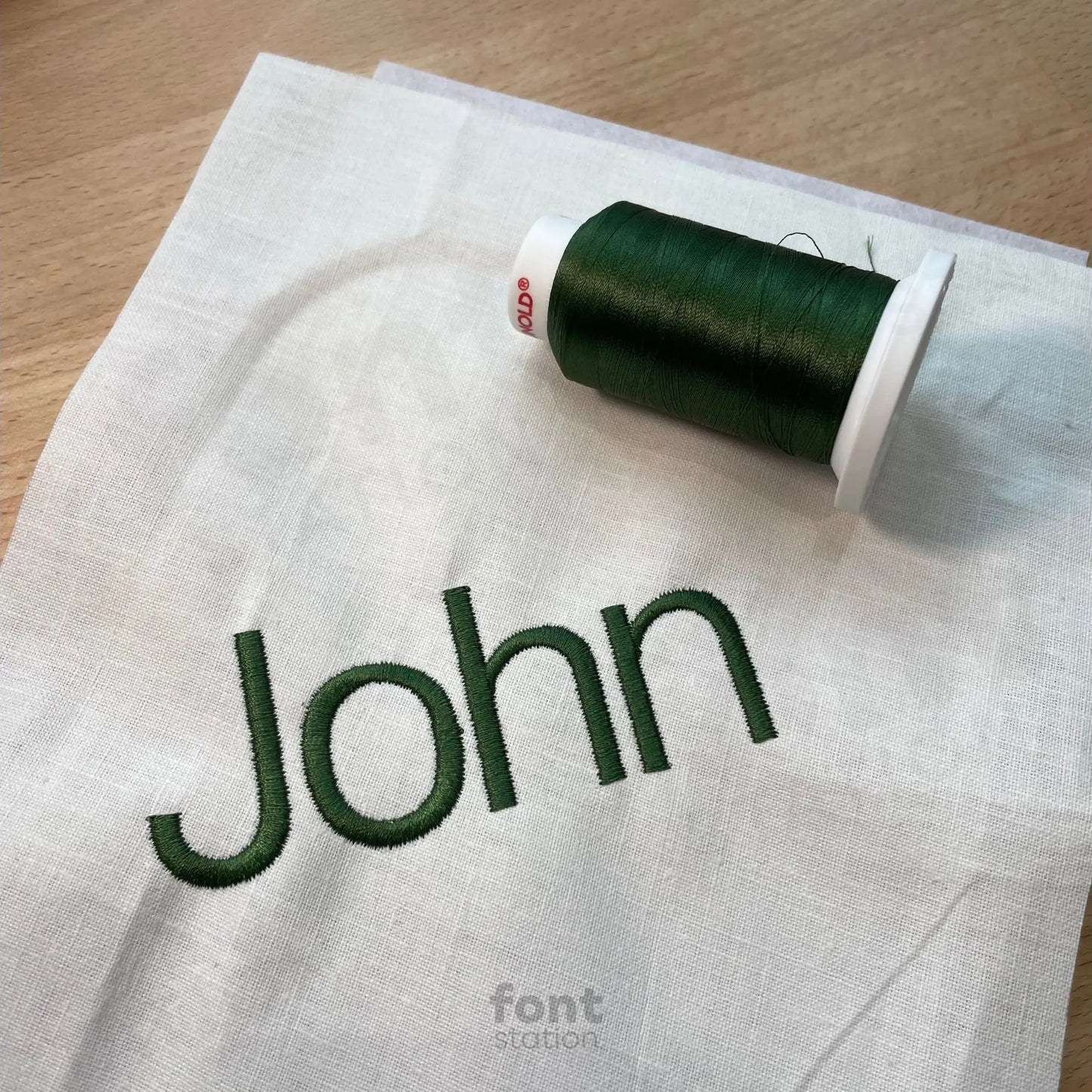 Image showing a word embroidered on textile using the Helvetica embroidery font created by FontStation