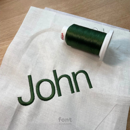 Image showing a word embroidered on textile using the Helvetica embroidery font created by FontStation