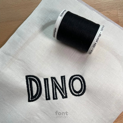 Image showing a word embroidered on textile using the Jurassic embroidery font created by FontStation