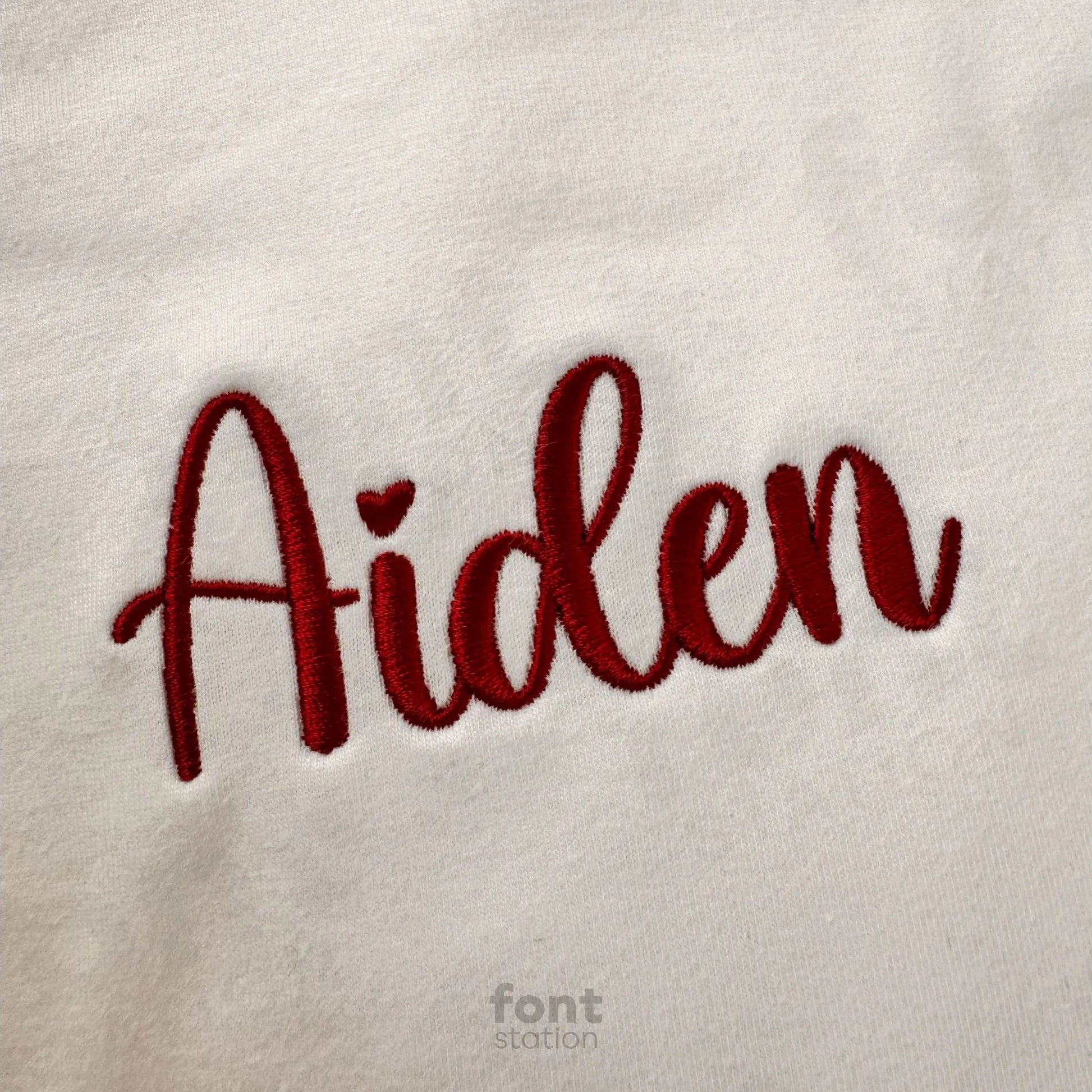 Image showing a word embroidered on textile using the Merci embroidery font created by FontStation