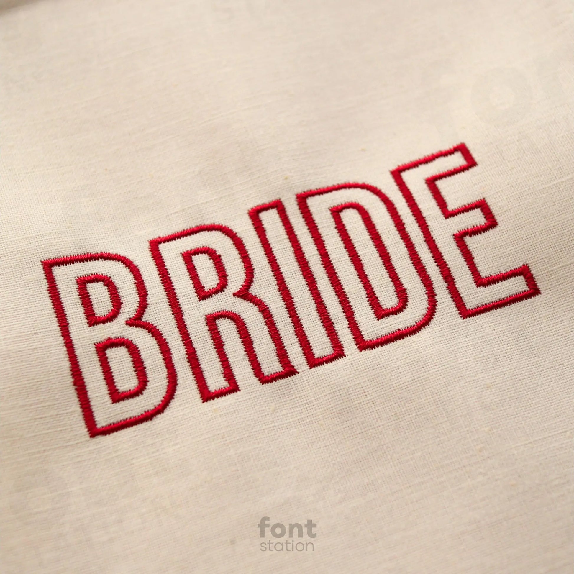 Image showing a word embroidered on textile using the Modern Outline embroidery font created by FontStation