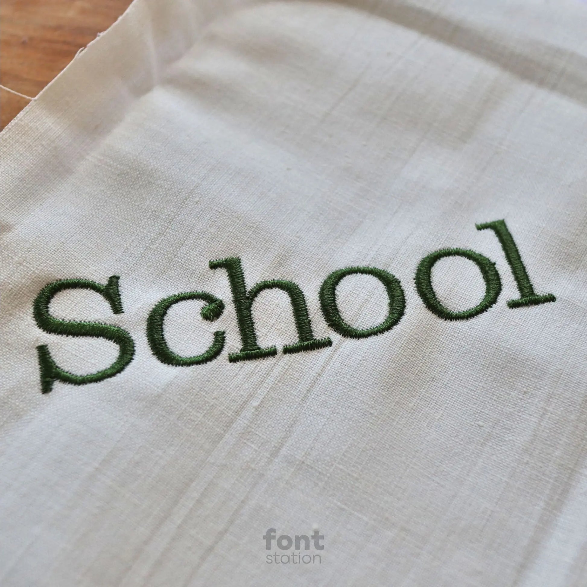 Embroidered letters using the School Book embroidery font created by FontStation