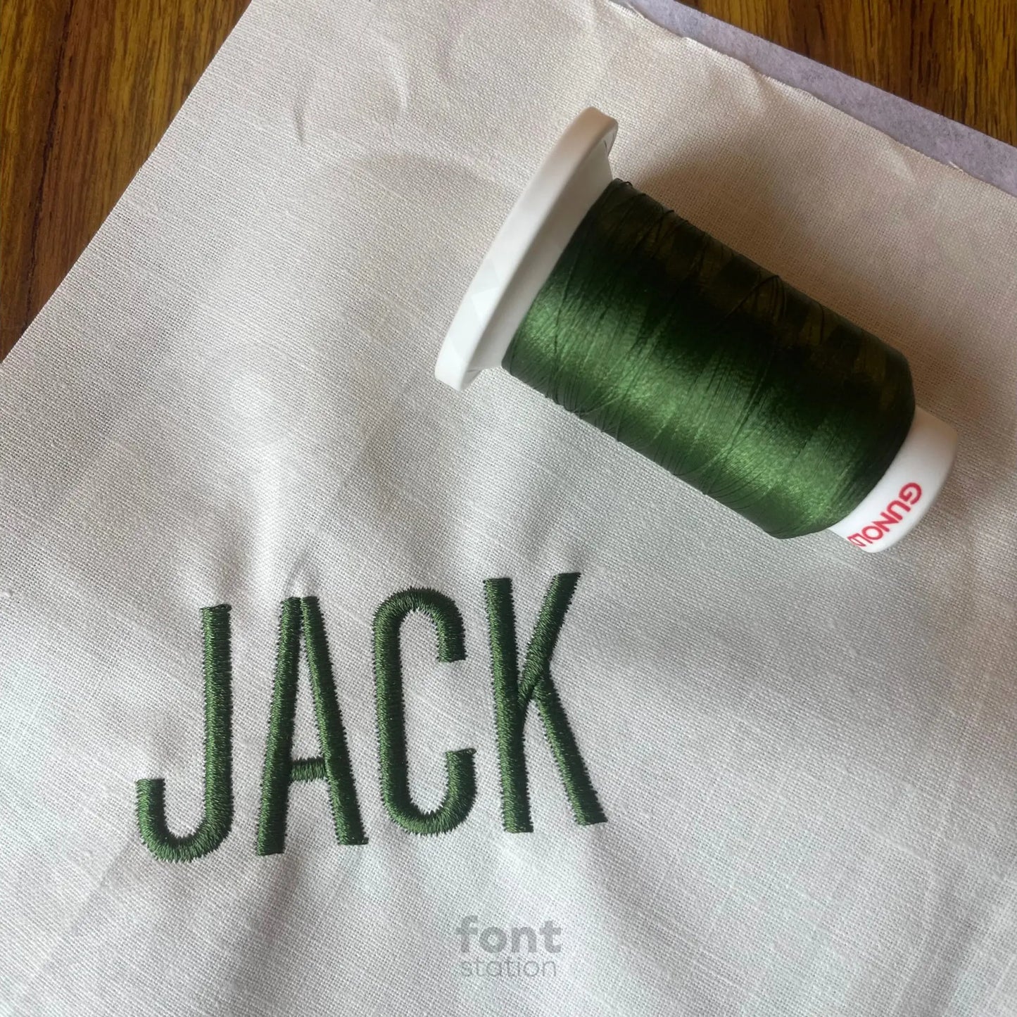 Image showing a word embroidered on textile using the Tall Block embroidery font created by FontStation
