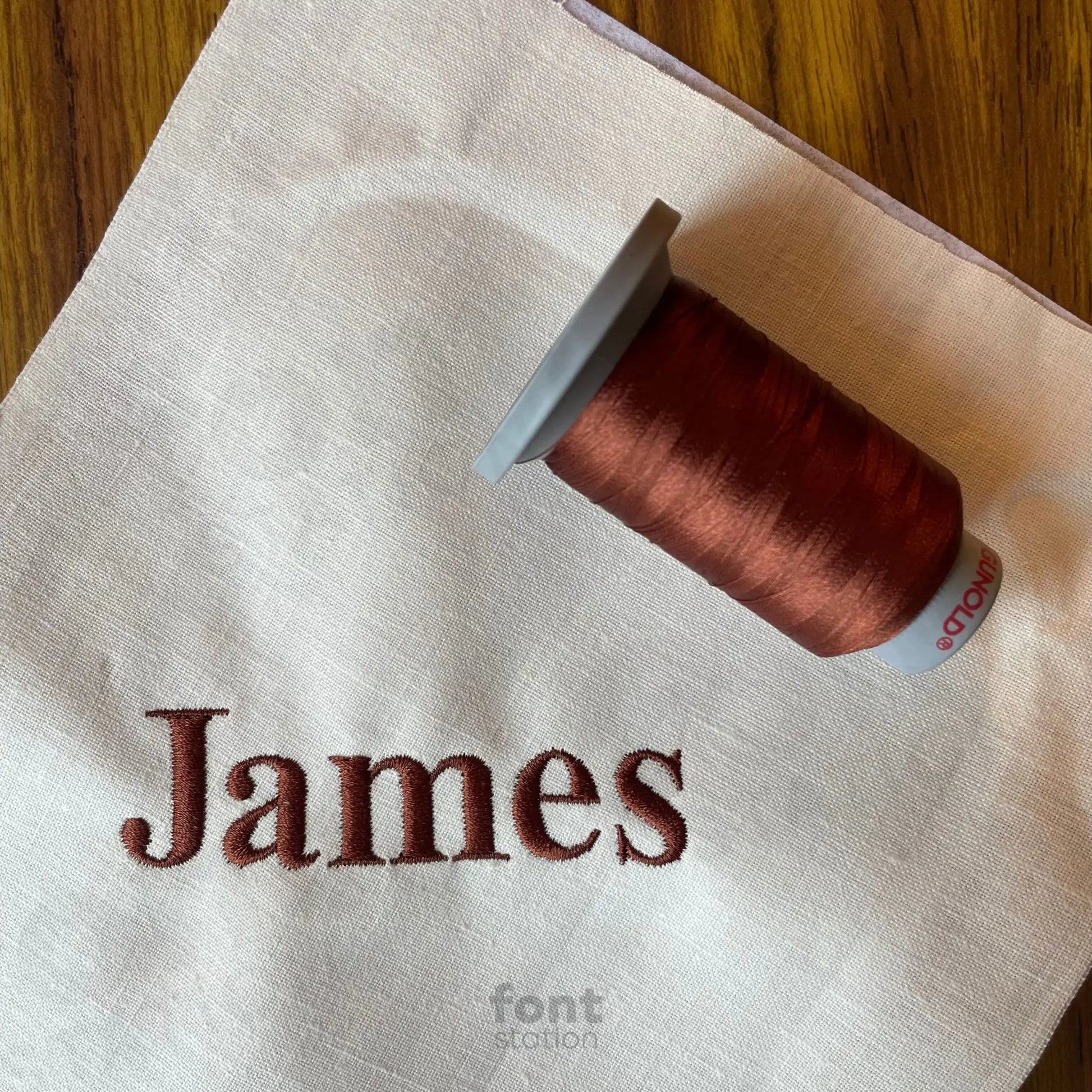 Image showing a word embroidered on textile using the Times Roman Bold embroidery font created by FontStation