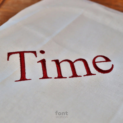Image showing a word embroidered on textile using the Times Roman embroidery font created by FontStation