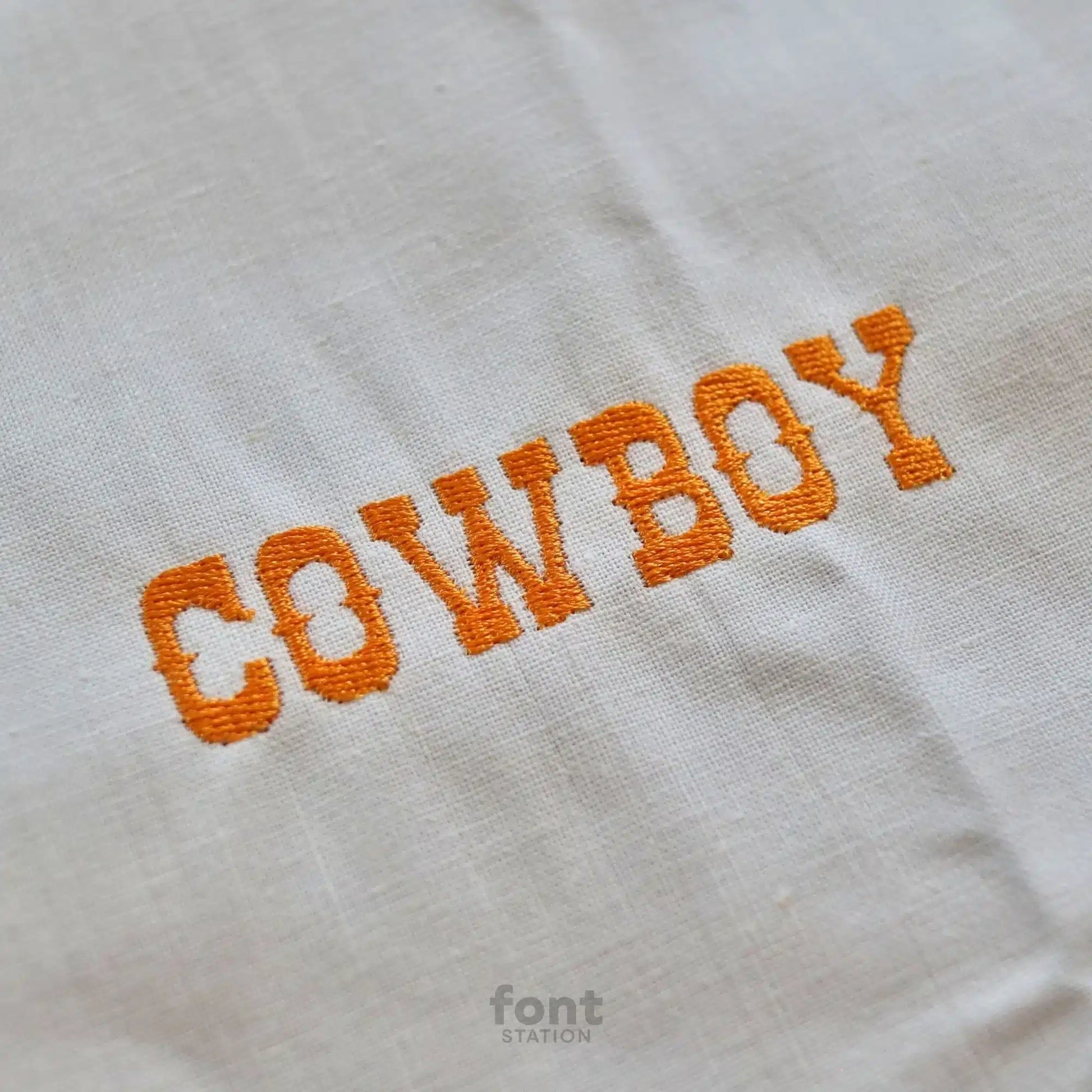 Image showing a word embroidered on textile using the Western embroidery font created by FontStation