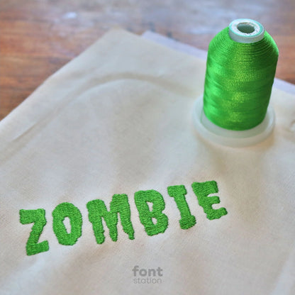 Image showing a word embroidered on textile using the Zombie embroidery font created by FontStation
